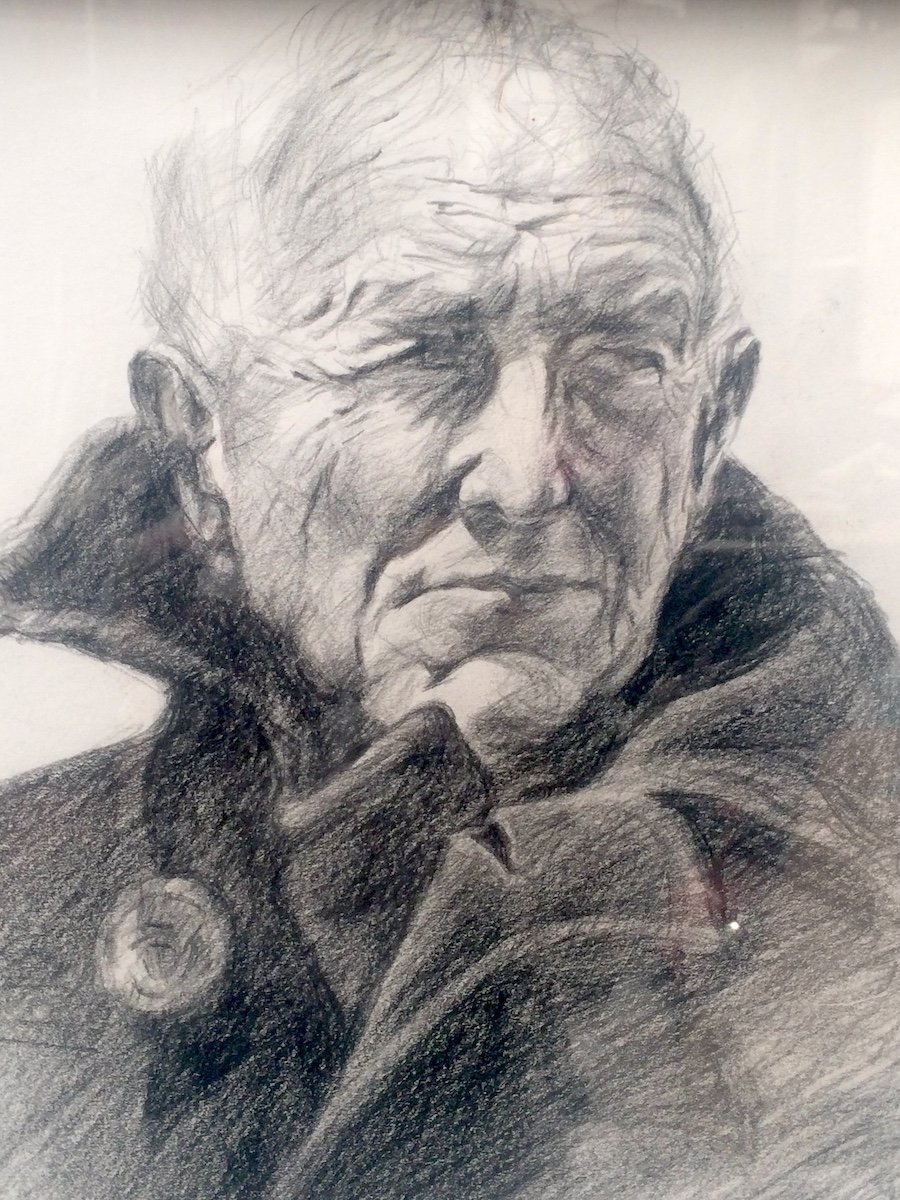 A detailed pencil sketch of an elderly man with a furrowed brow, deep-set eyes, and a contemplative expression, resting his chin on his hand.