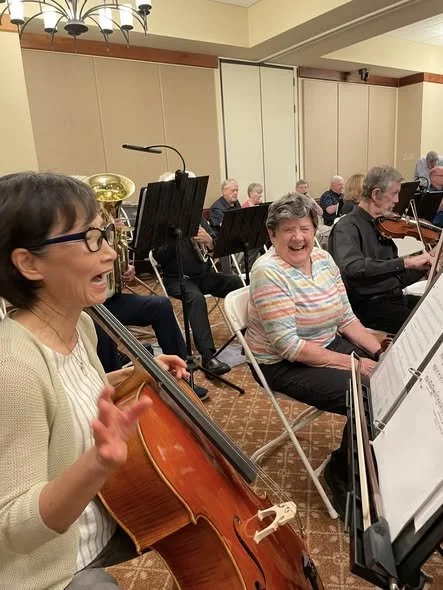 Female members of the New Horizons Band of Austin, Texas warming up prior to a concert.