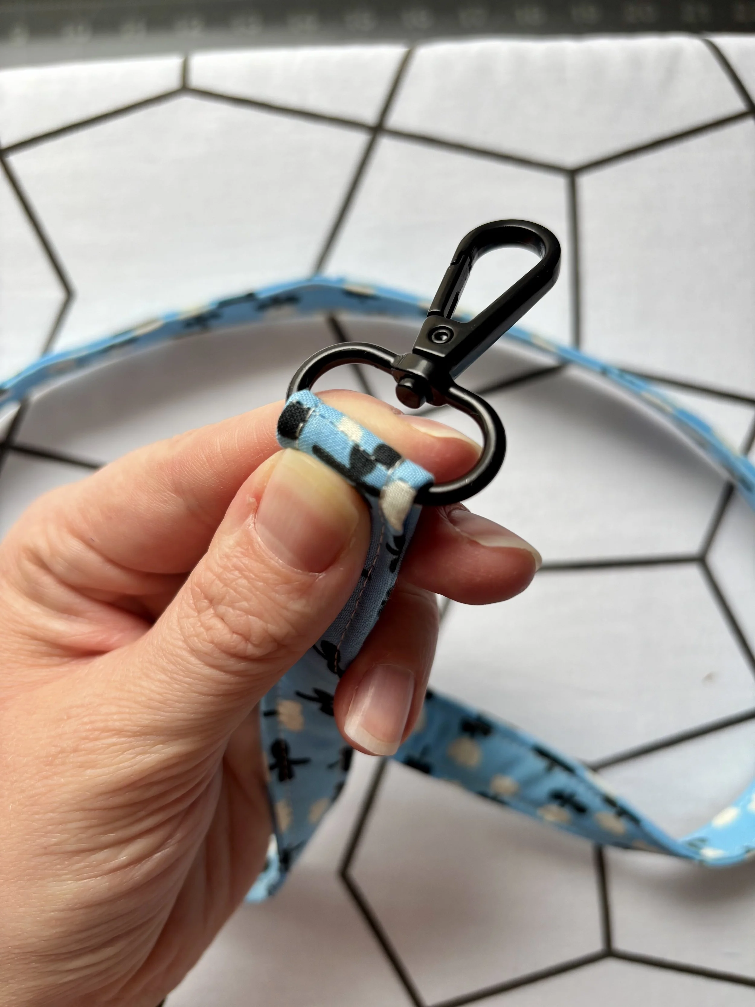 A photo of the loop seam straddling the hardware before stitching in place