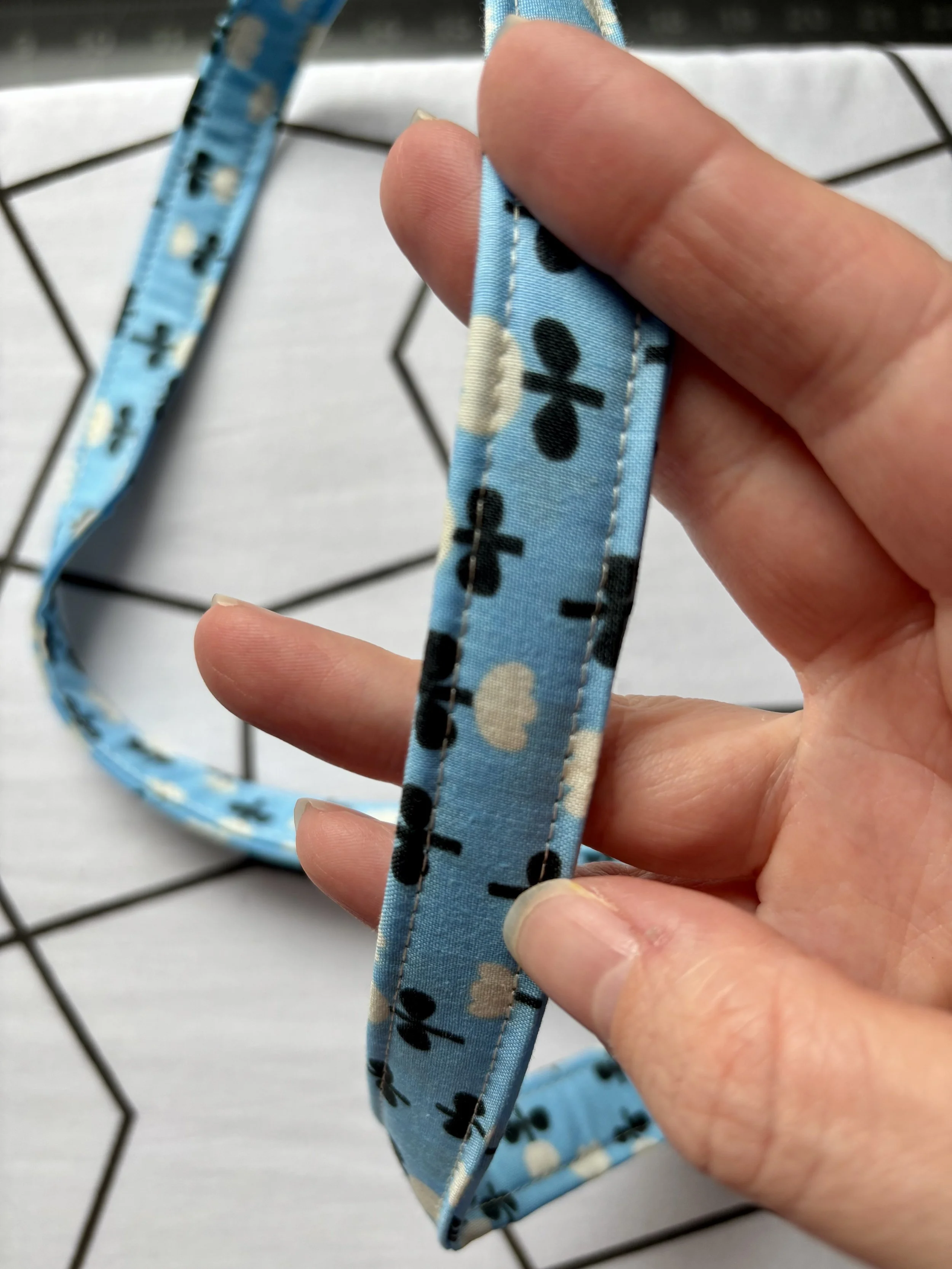 A photo of the lanyard with completed edgestitching on each side of the fabric
