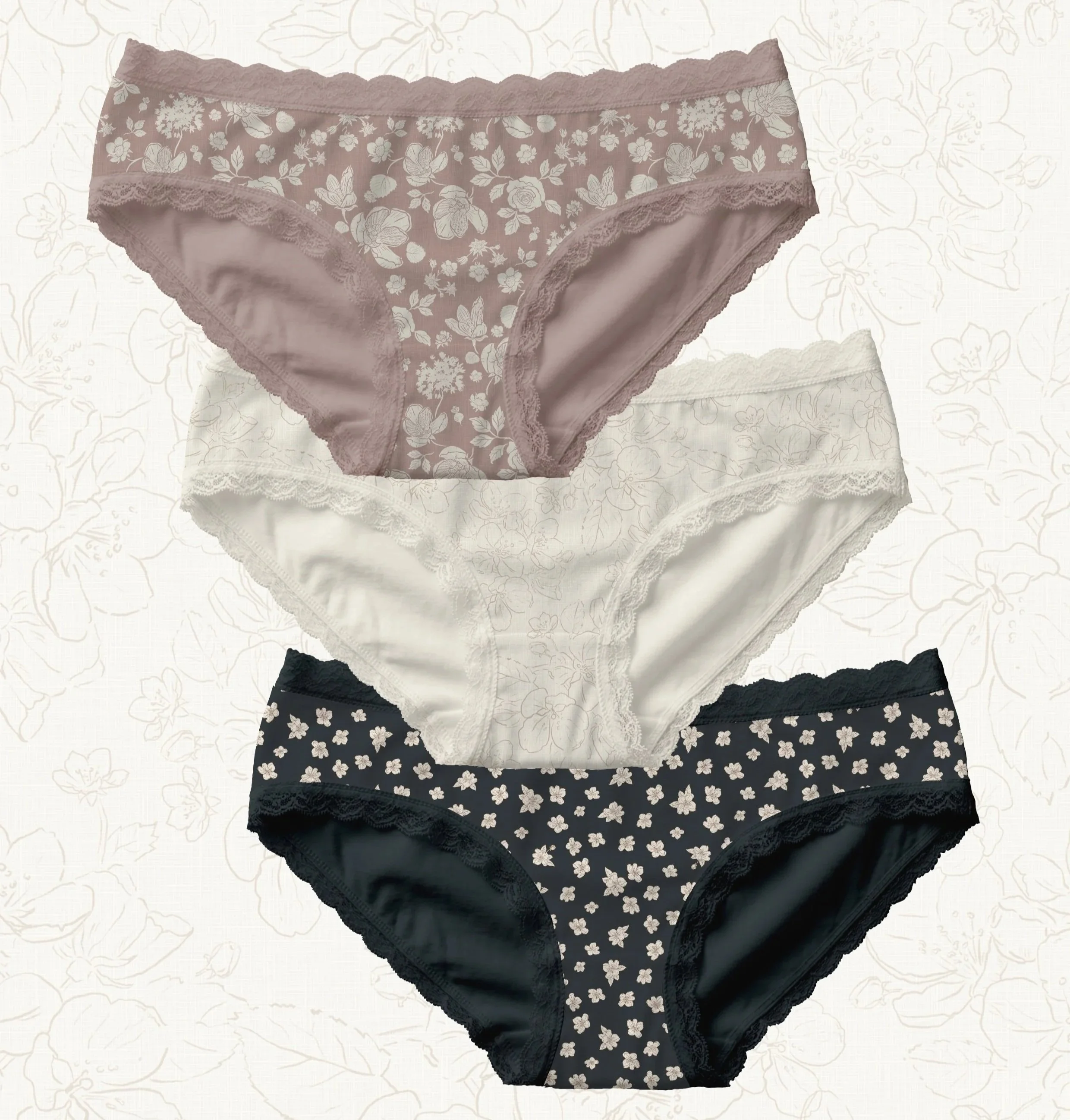 Three pairs of women's lace-trimmed floral-patterned underwear in mauve, white, and black with white floral designs.