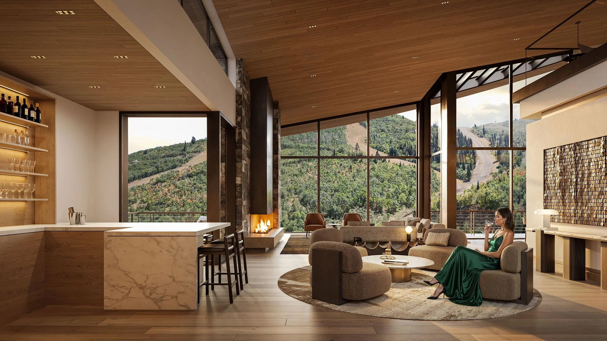 Modern living room with large floor-to-ceiling windows showing a forested mountain landscape, featuring a woman in a green dress sitting on a sofa, drinking from a glass, with a fireplace and contemporary furniture.