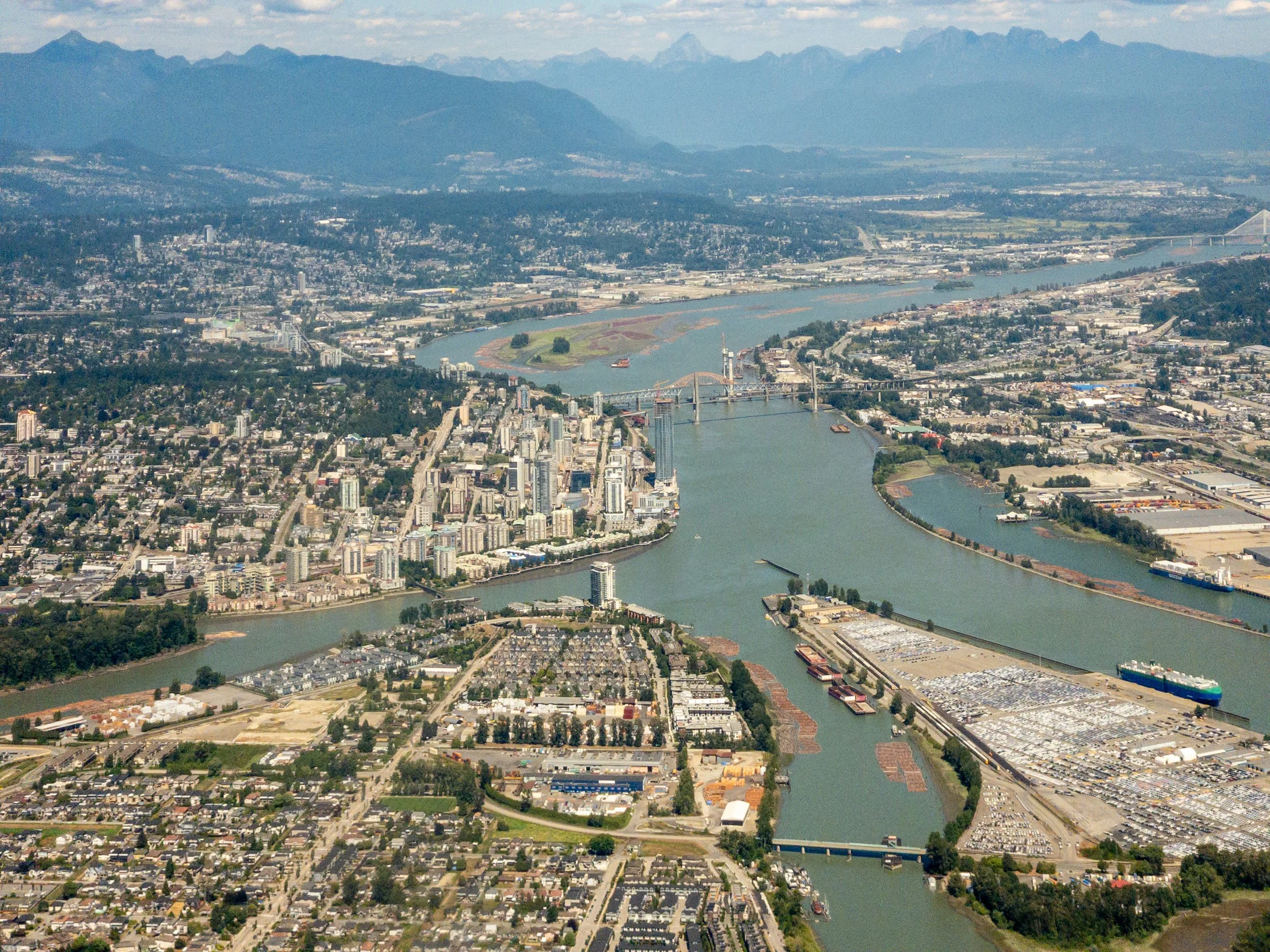 Terminal City
An expansive aerial view of Vancouver, showing the dense urban core nestled between the Burrard Inlet and the Fraser River. The shot captures the unique "Vancouverism" architecture—slim residential towers designed to preserve mountain v