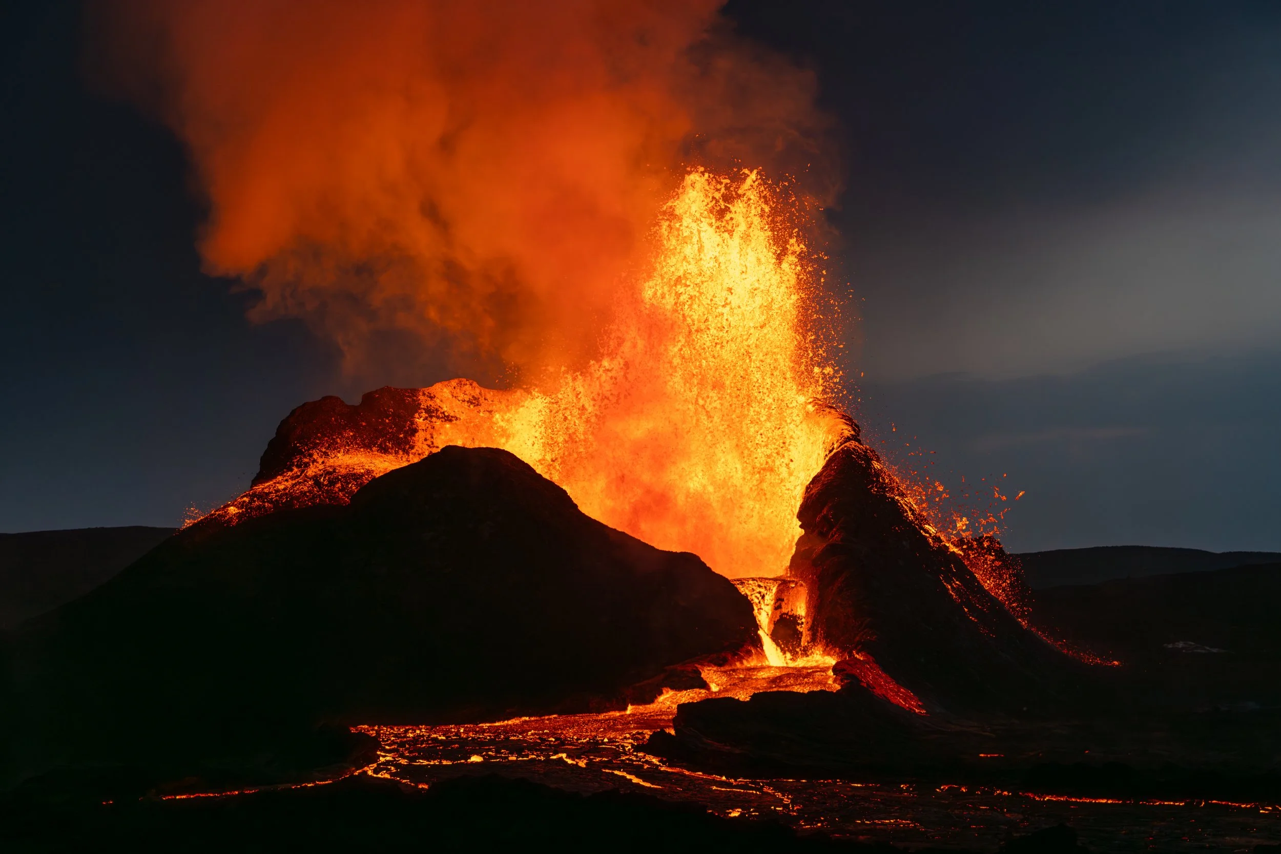 Fire of the Deep
A tight perspective on a fountaining event, where molten rock is sprayed with immense pressure from the earth’s mantle. The vibrant orange hue indicates the extreme temperature of the fresh basalt before it begins its transition into