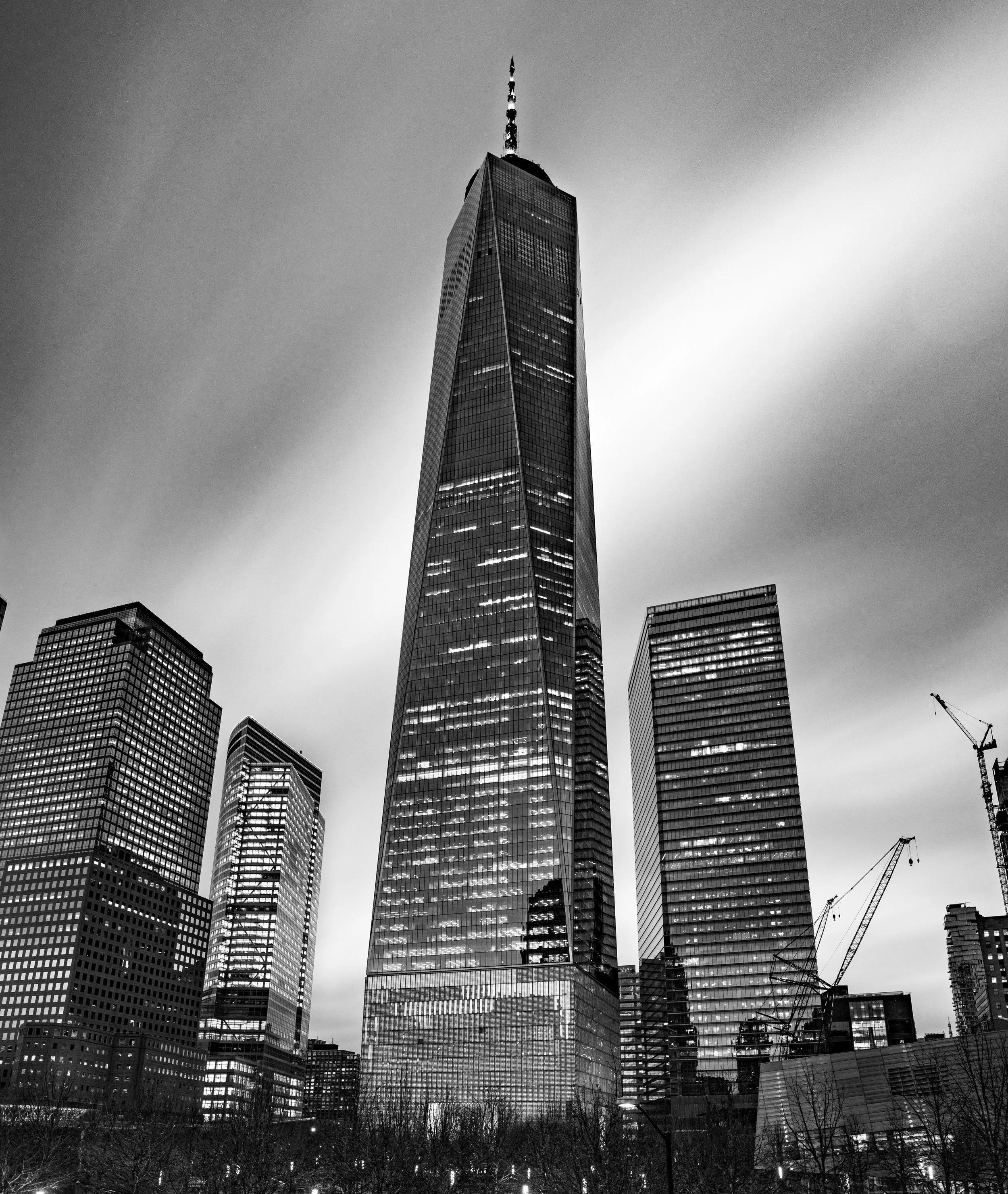 Monolithic Geometry
A stark, black-and-white study of the One World Trade Center. By stripping away color, this composition emphasizes the triangular facets and reflective glass of the "Freedom Tower." The high-contrast edit highlights the building’s