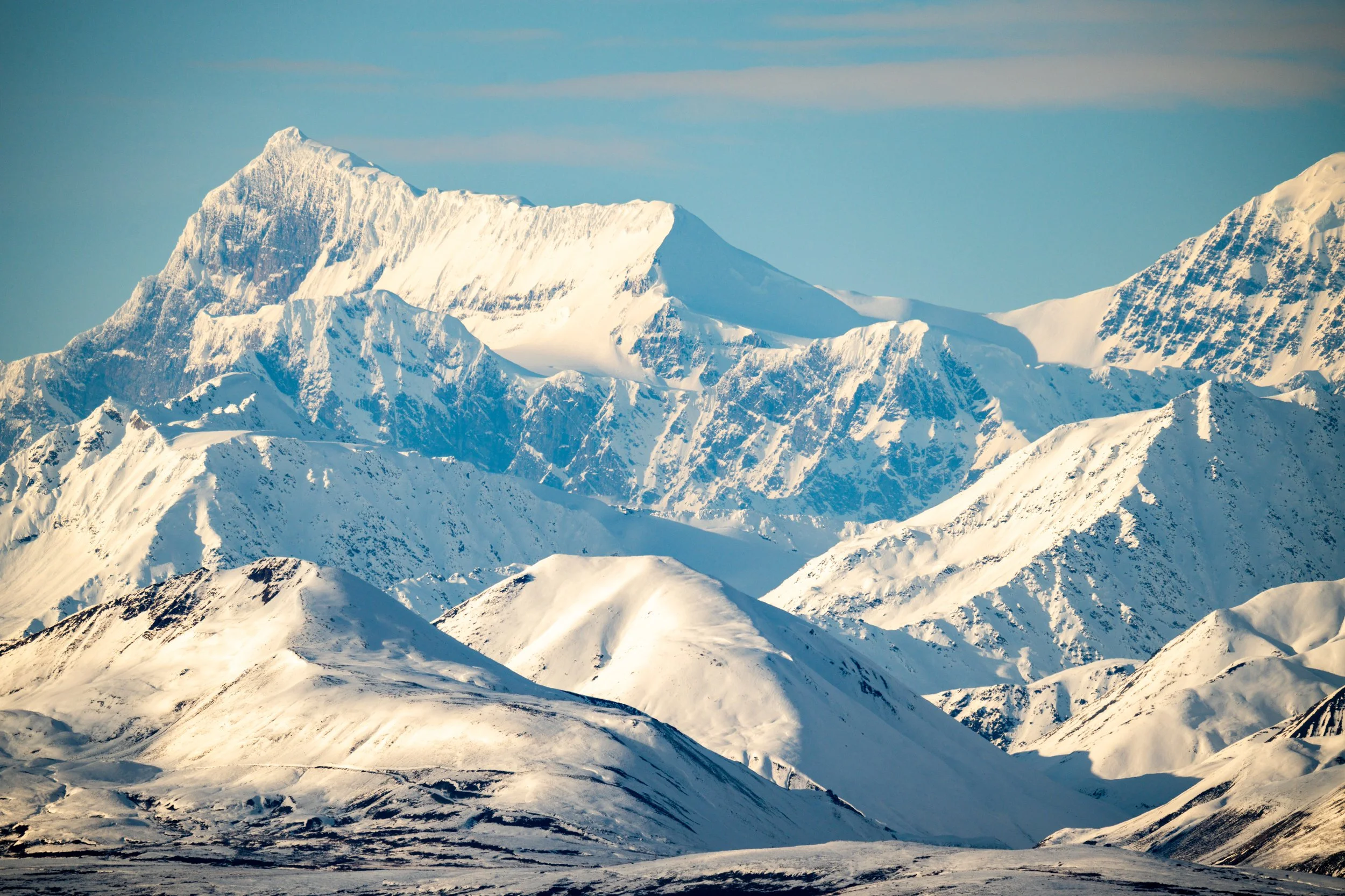 Alaskan Interior
A wide, cinematic view of the rugged, snow-dusted spine of the Alaska Range.