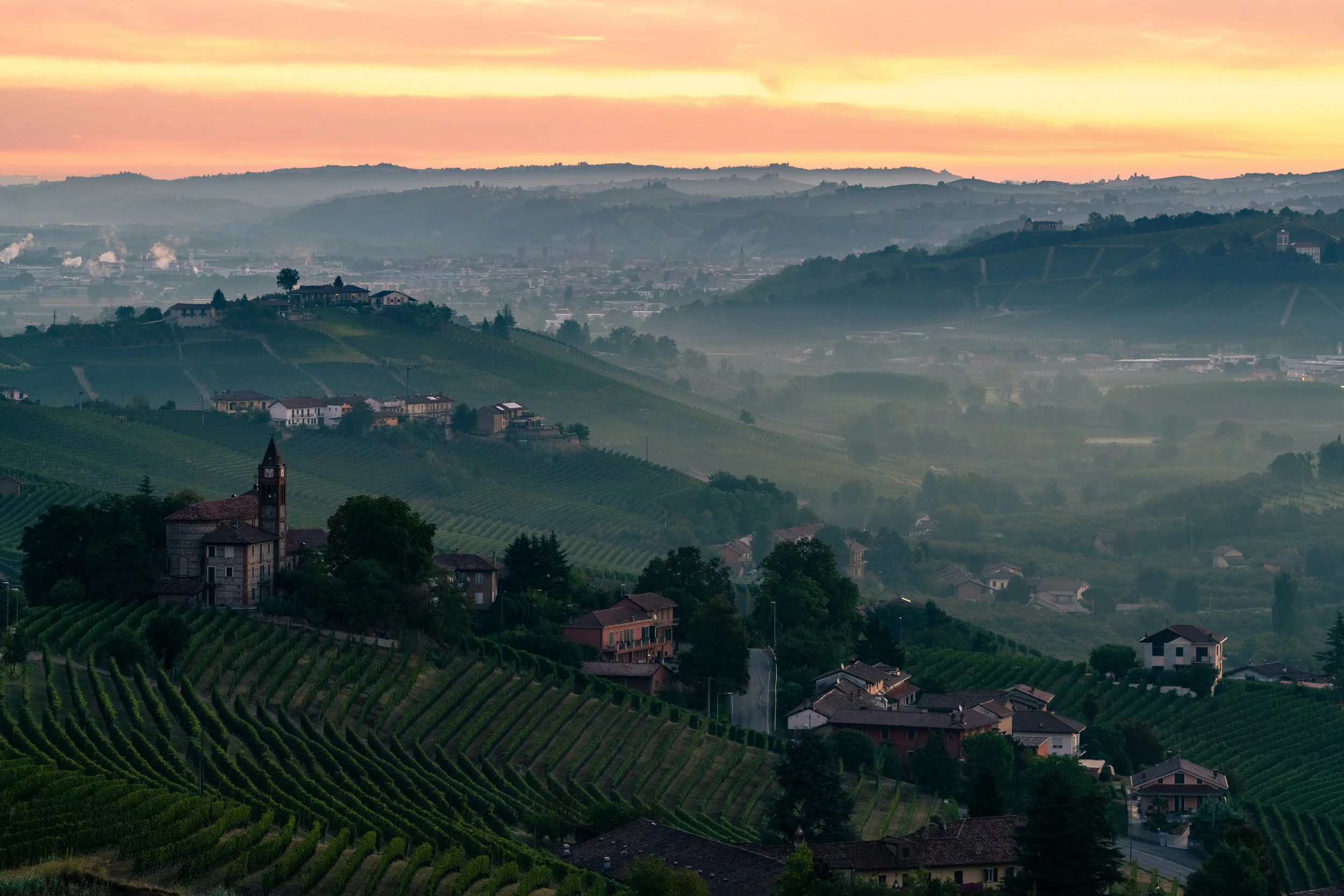 The Floating Fortress
 A magical, atmospheric capture of a historic hilltop tower rising above a thick blanket of morning fog. The soft, warm light of dawn paints the mist and the exposed ridges of the valley, creating a dreamlike, layered landscape.