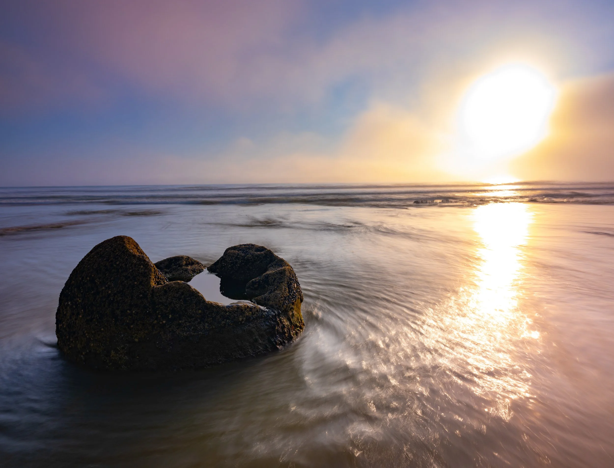 The Spheres of Moeraki
Scattered along the Koekohe Beach on New Zealand's Otago coast, these spherical boulders are a geological phenomenon. Known as septarian concretions, they formed in ancient sea floor sediments approximately 60 million years ago