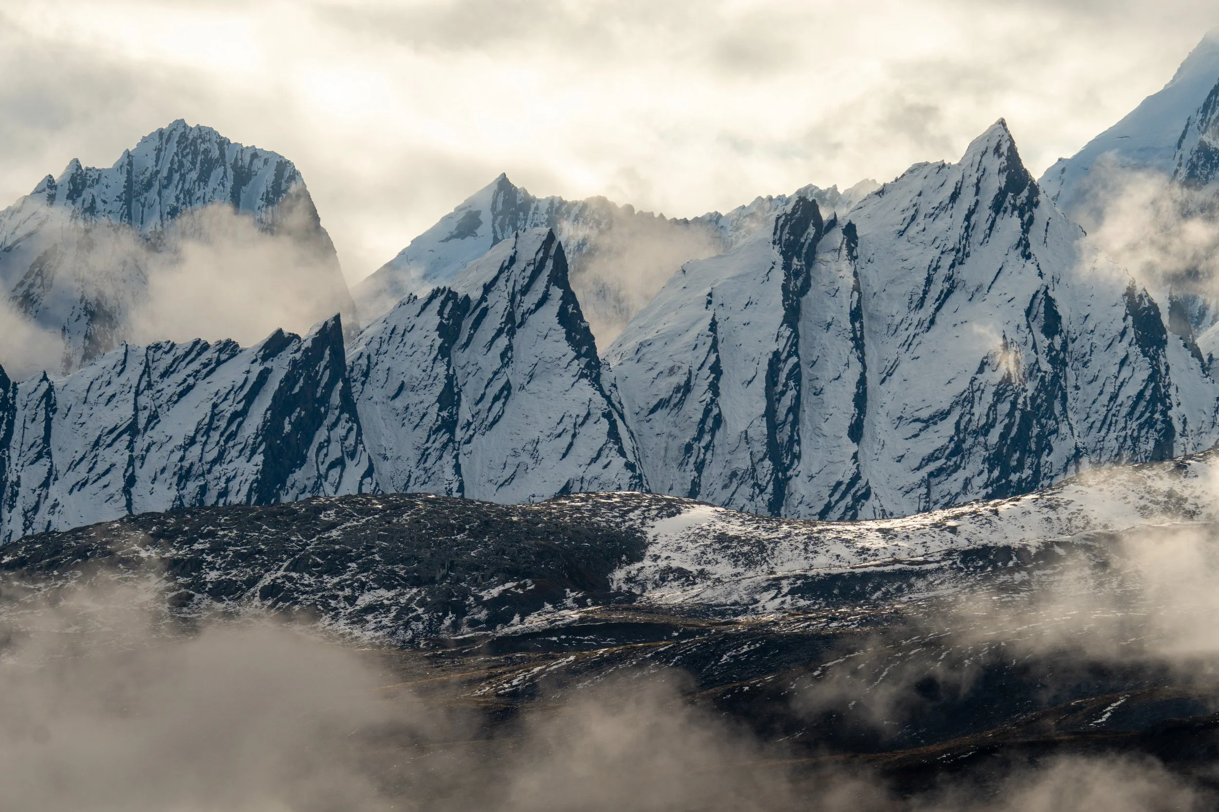 Through the mist
Jagged, snow-dusted peaks of the Alaskan wilderness.