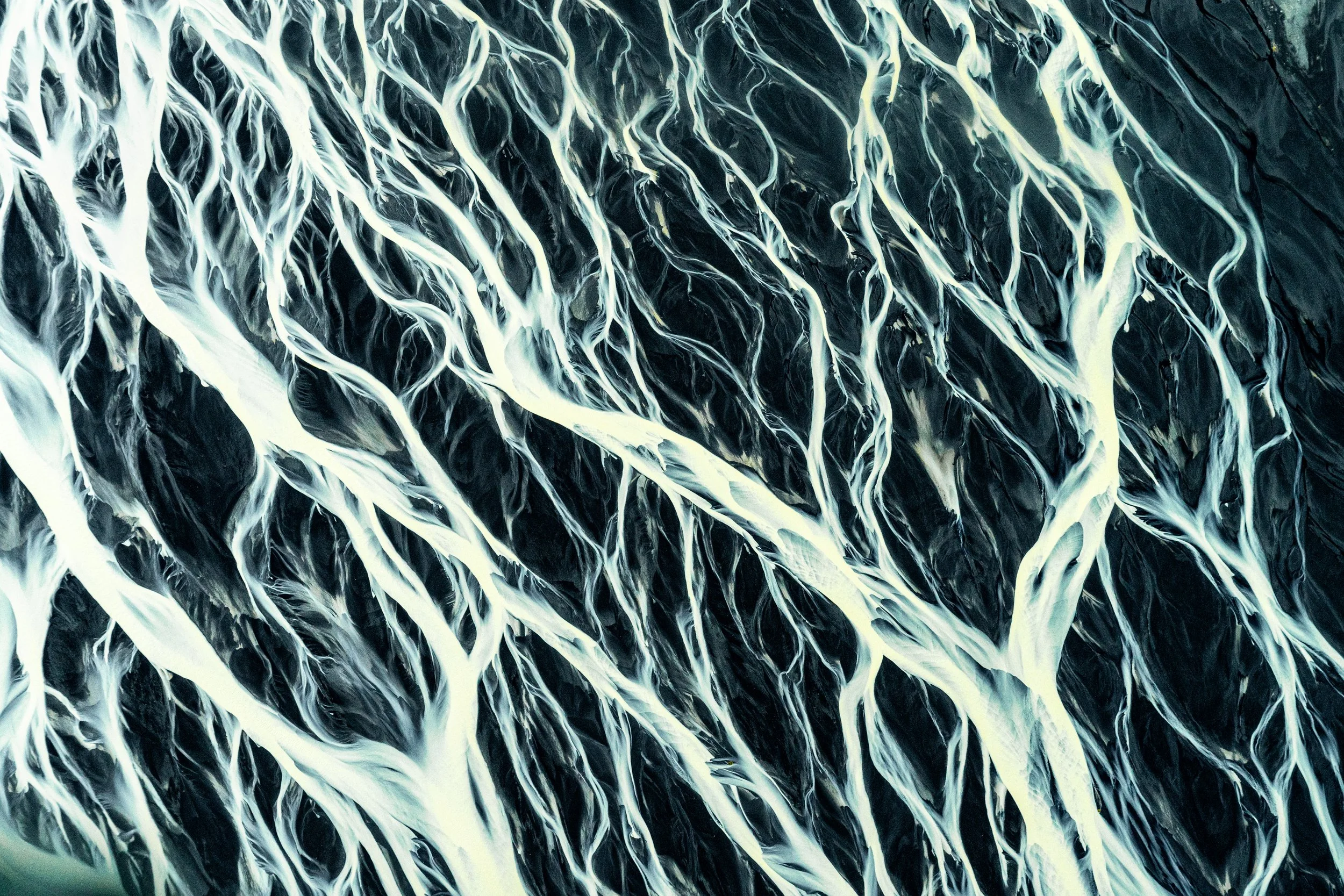 The Braided Path
A close-up aerial shot focusing on the intersection of multiple water streams. This image highlights the texture of the riverbed, where the water’s velocity determines the color and clarity of each individual channel, resulting in a 