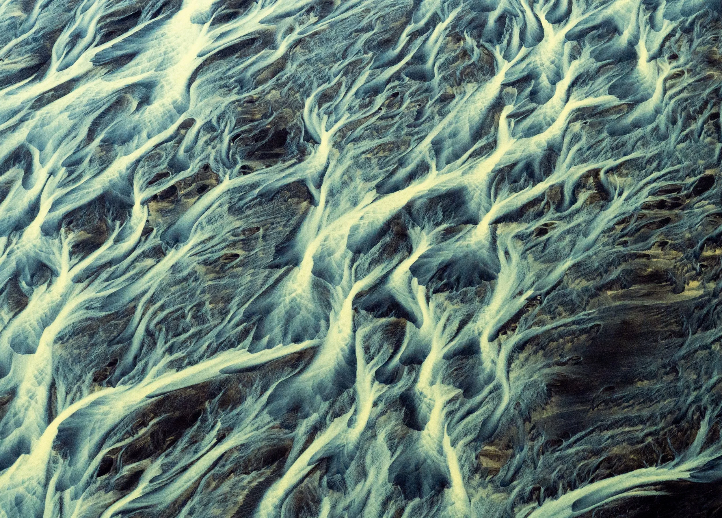 The Arctic Nerve
A high-contrast shot where the thin, delicate streams of water resemble a neural network. This perspective emphasizes the fragility and interconnectedness of the Icelandic ecosystem, where the glaciers in the highlands provide the li