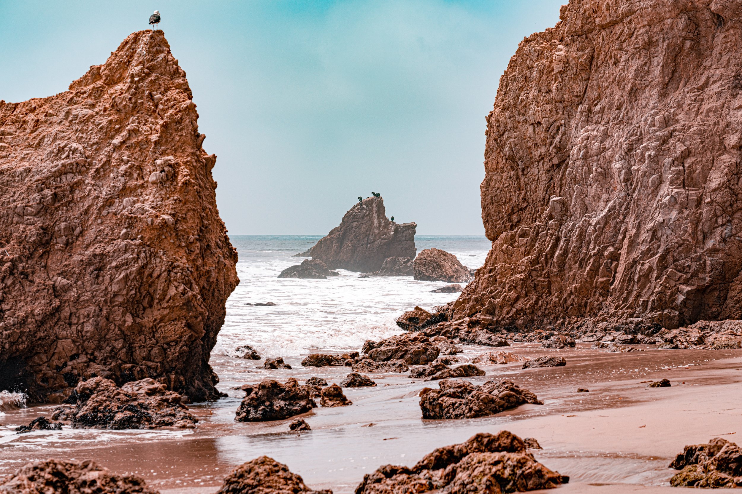 The Sea Stacks of Malibu
Jagged rock formations, or "sea stacks," rise dramatically from the sands of El Matador State Beach. These monolithic structures are the remnants of ancient cliffs, eroded over millennia by the relentless pounding of the Paci