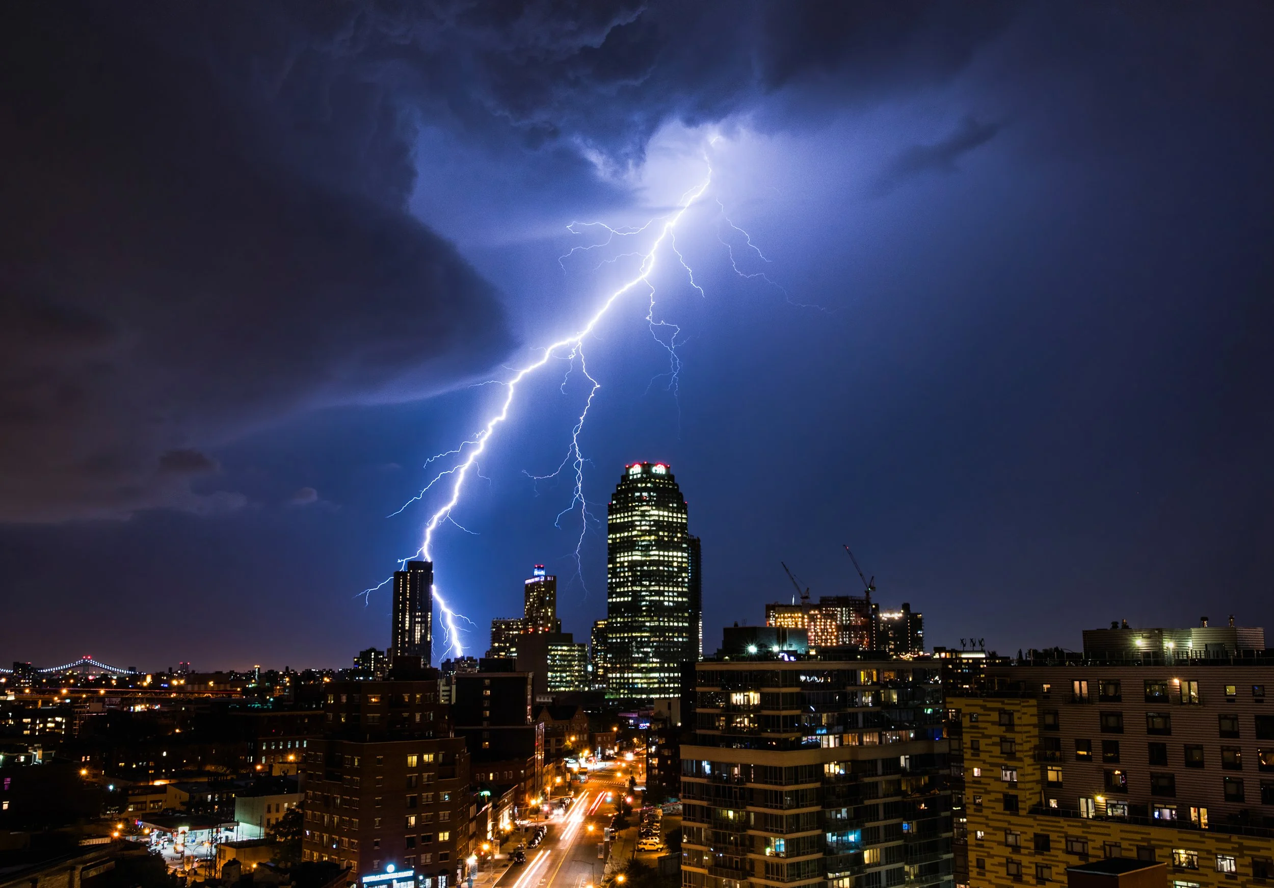 The Electric Skyline
A well timed long exposure capturing a massive lightning bolt striking near the Optimum (formerly Citibank) Building in Long Island City. The purple and blue hues of the storm clouds provide a dramatic backdrop to the illuminated