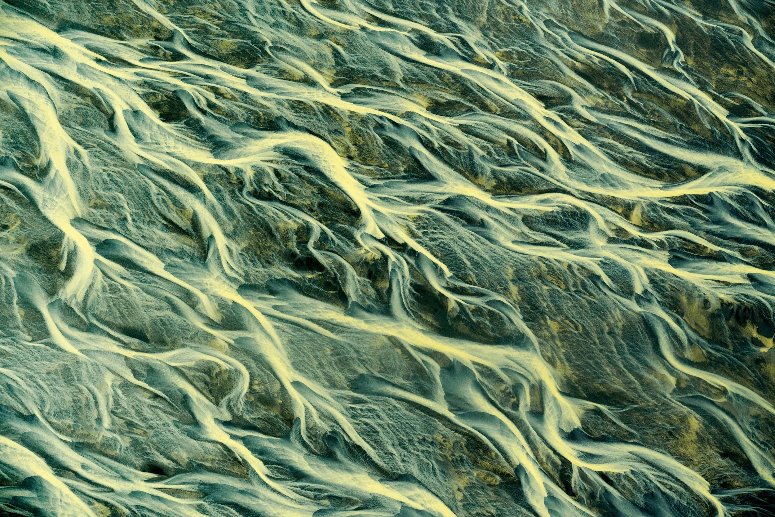 The Delta’s Reach
As the river approaches the Atlantic, the channels become wider and more shallow. This image captures the vastness of the Icelandic "Sandur"—the massive glacial outwash plains—where the water finally slows down before meeting the se