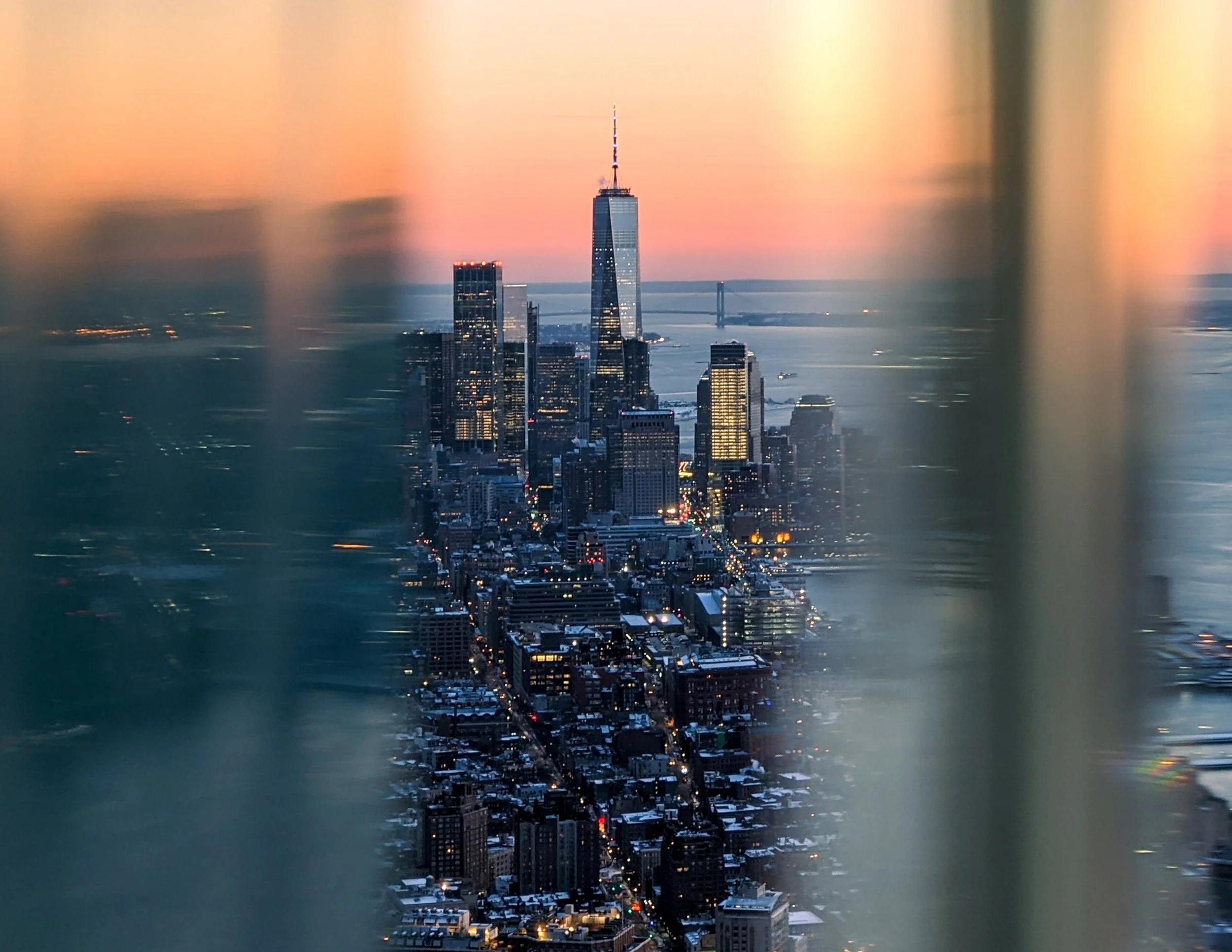 Gotham’s Golden Hour
A dramatic, high-altitude view looking down into the canyons of Manhattan. The warm glow of the streetlights contrasts with the cool, blue glass of the skyscrapers, capturing the city in its transition from day to night. This per