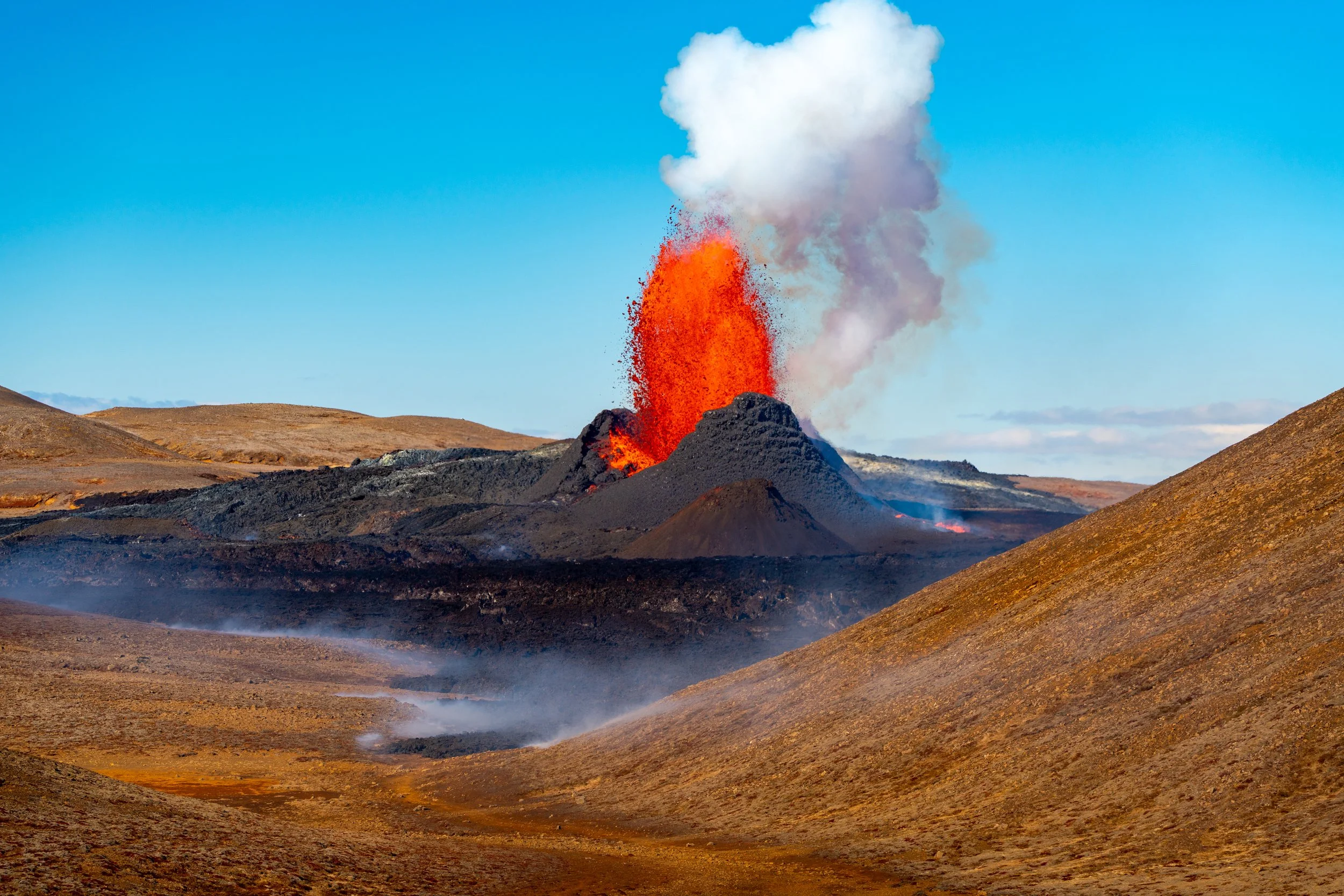 Under Pressure
A brilliant orange lava fountain surges from the central vent of the Fagradalsfjall eruption. This image captures the moment of peak pressure, where molten rock is ejected with enough force to build the surrounding cinder cone. Against