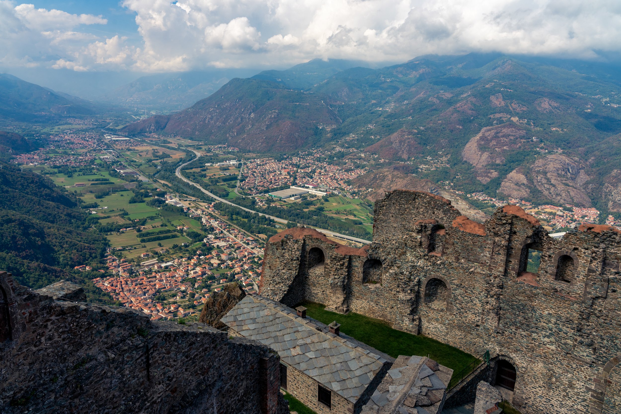 The Silent Sanctuary
Perched precariously on a rocky outcrop, the ruins of the San Michele Convent overlook a deep, mist-filled valley. This shot captures the haunting beauty of the ancient stone walls against the vast, atmospheric backdrop of the Do