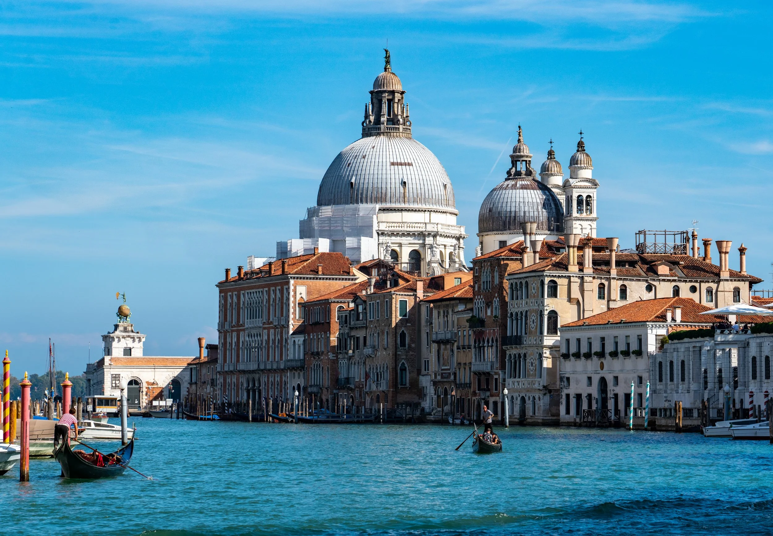 The Grand Canal
Looking across the water toward the iconic domes of Santa Maria della Salute in Venice. This shot captures the Baroque masterpiece framed by the wooden pylons and passing vaporettos of the Grand Canal. The soft, maritime light emphasi