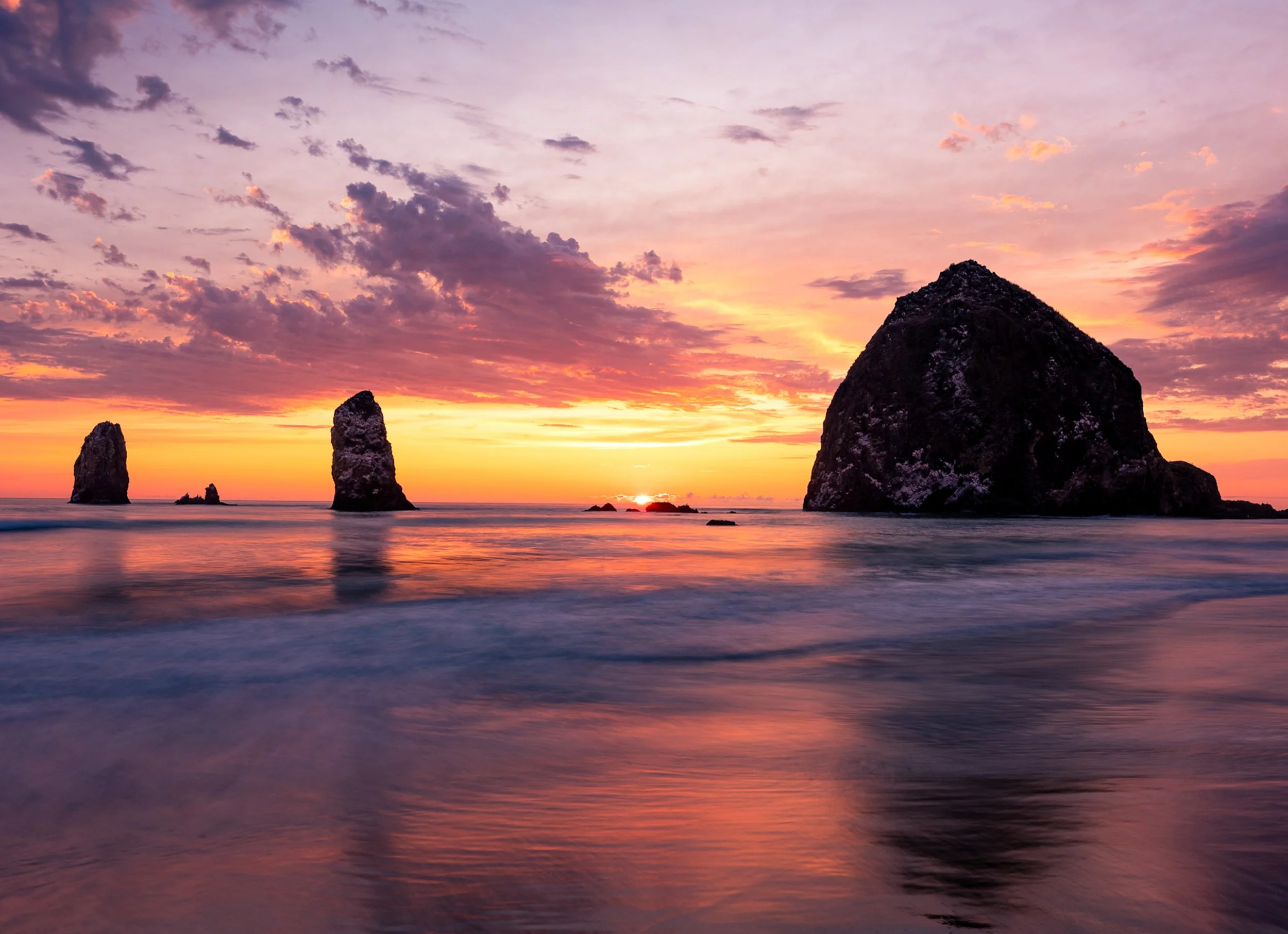 Sunset among Seastacks
As the sun dips below the horizon, the silhouettes of ancient sea stacks emerge against a burning sky. These rugged formations are geological survivors, composed of harder rock that resisted the relentless erosion of the Pacifi