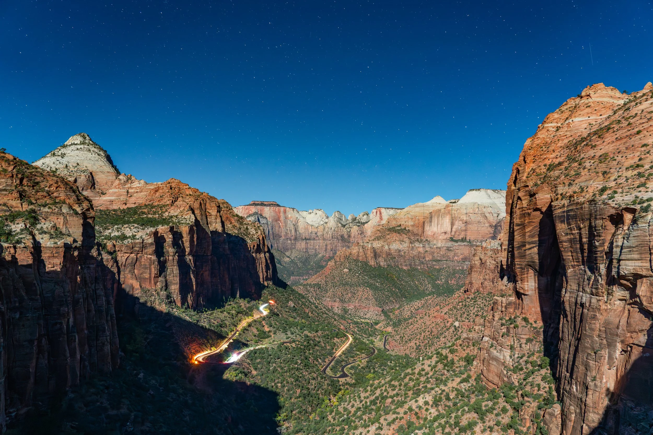 Zion Canyon
A look at the towering walls of Zion National Park. This shot emphasizes the massive scale of the Navaho Sandstone cliffs as they rise vertically from the valley floor, displaying the rich reds and deep oranges characteristic of the Virgi