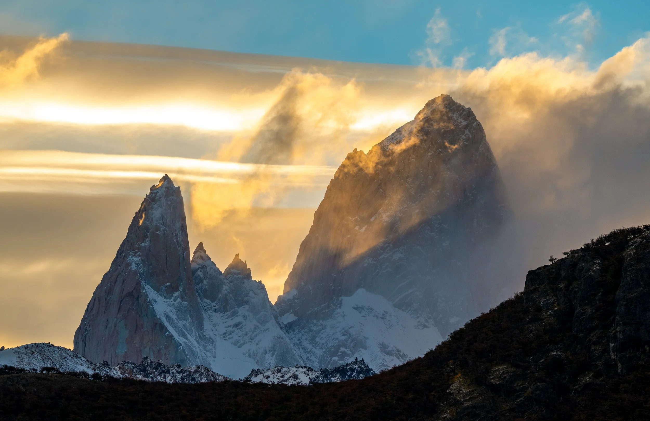 Fitz Roy at First Light 
A view from the Mirador del Fitz Roy outside of El Chaltén. The granite teeth of the massif piercing the clouds represent the raw, untamed spirit of Patagonia.