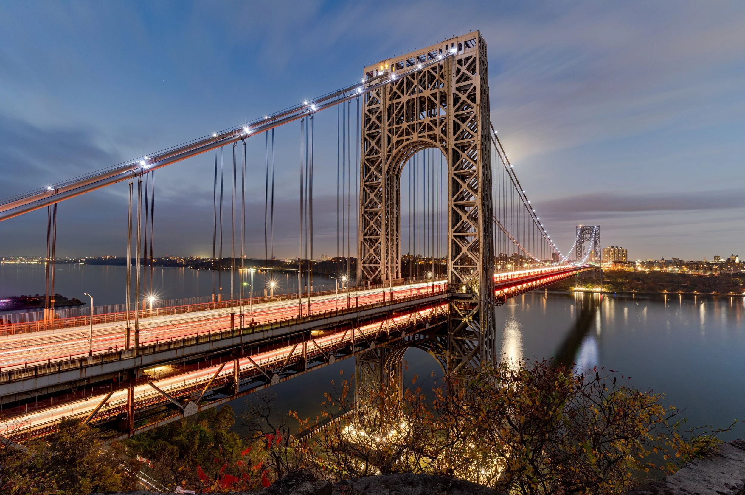 The GW Bridge
A long exposure of the George Washington Bridge during the blue hour. The extended shutter speed transforms the heavy traffic into vibrant ribbons of light, contrasting with the solid, illuminated steel of the bridge's towers. This shot