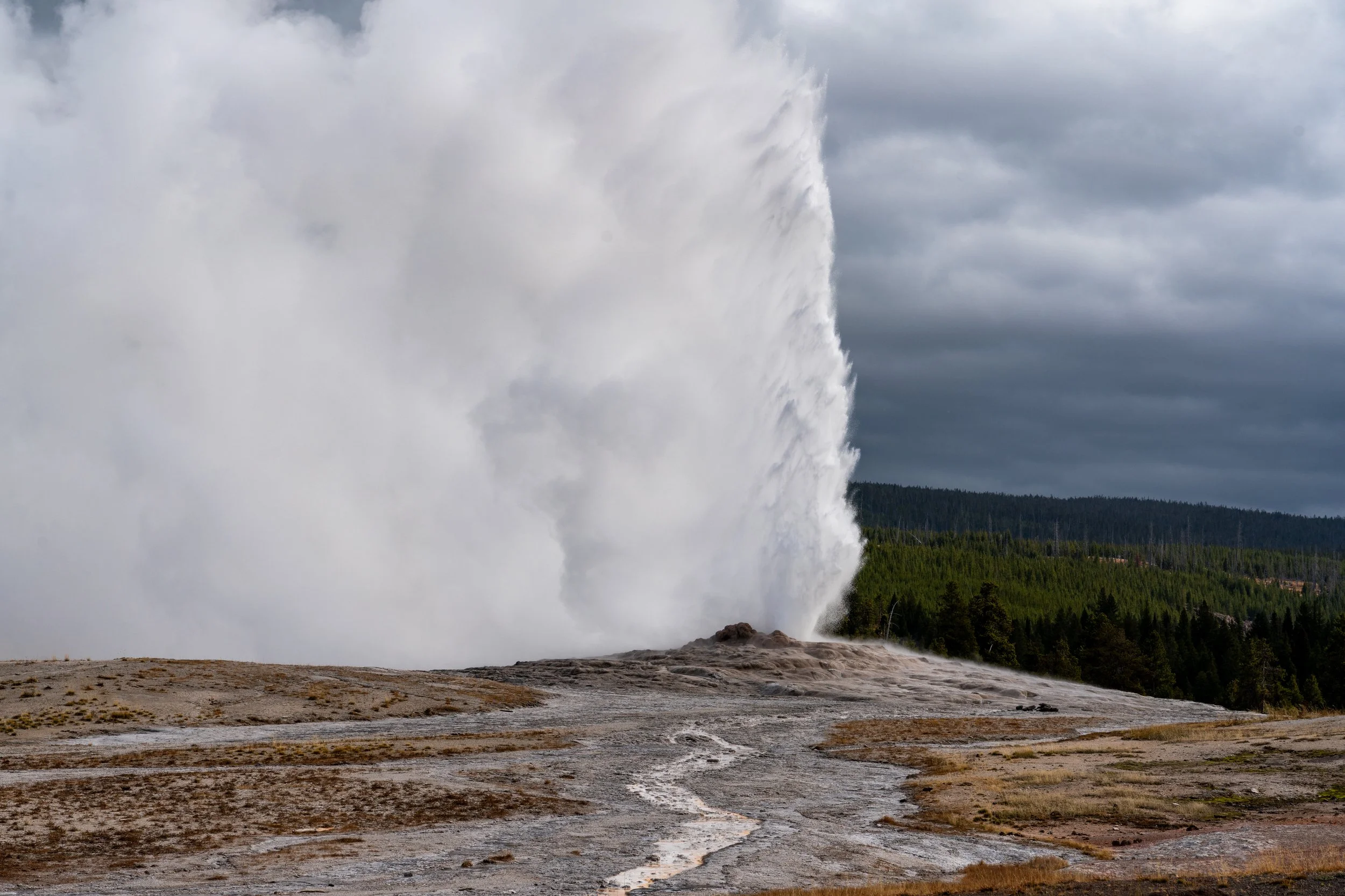 Old Faithful
A powerful eruption of Yellowstone’s most iconic hydrothermal feature. This geyser earns its name by erupting with remarkable consistency, shooting thousands of gallons of boiling water up to 180 feet into the air. This shot captures the