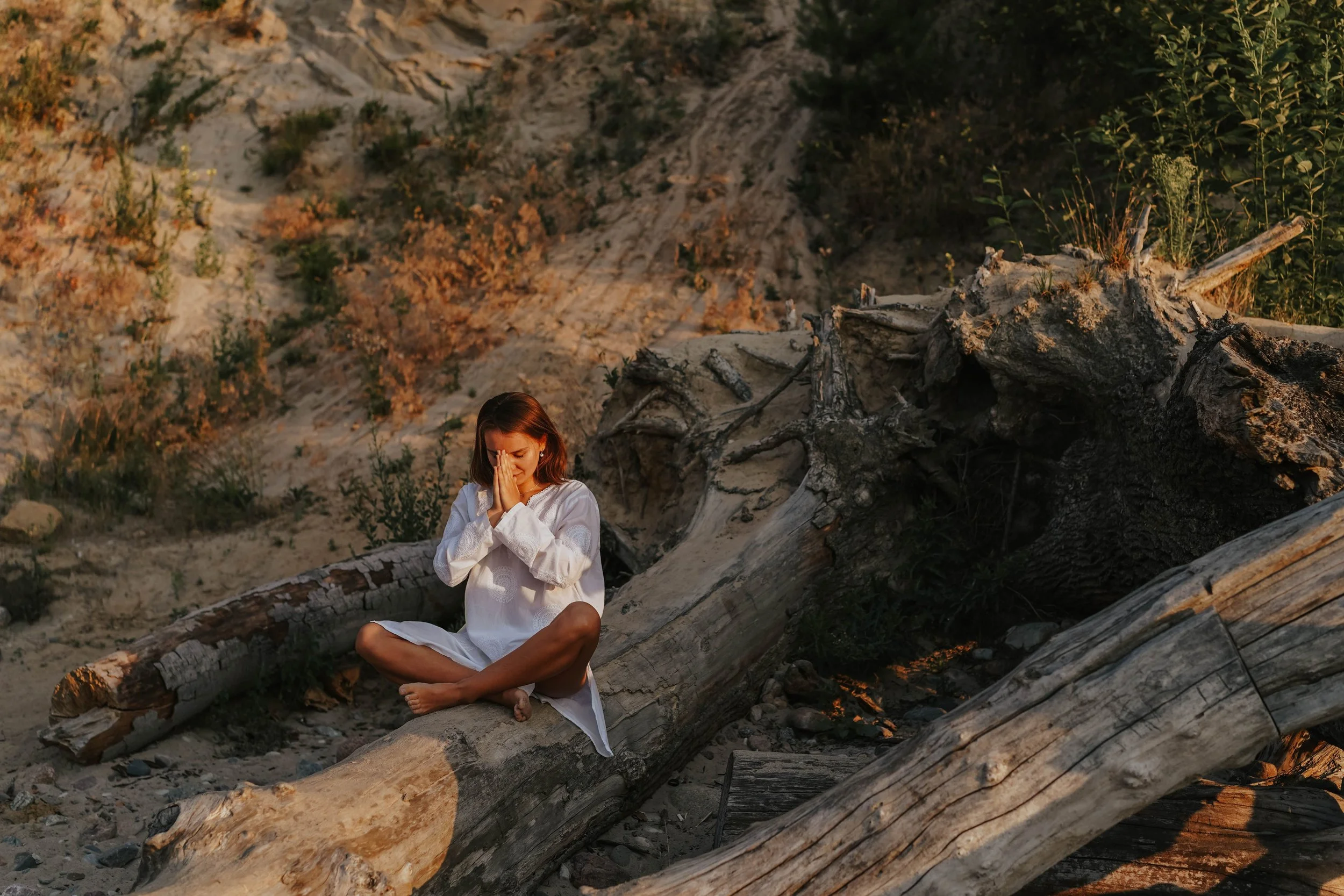 Woman sitting outdoors in a quiet natural setting