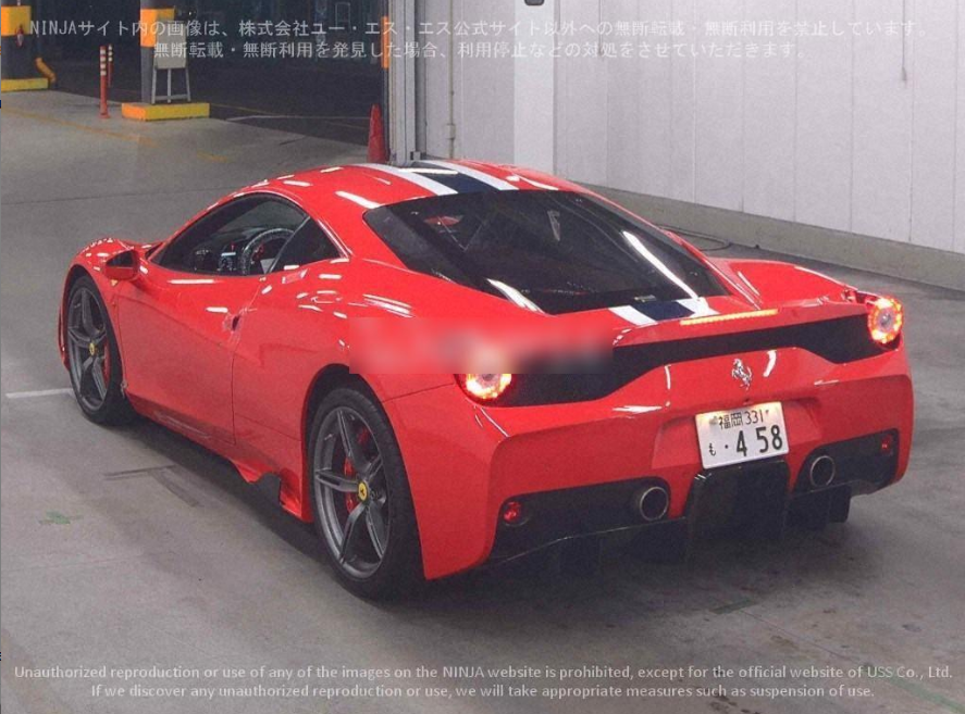 Red Ferrari sports car with black racing stripes parked in a garage or parking lot.