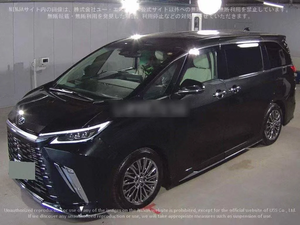 Black Lexus minivan parked indoors with overhead lights reflecting on its surface.