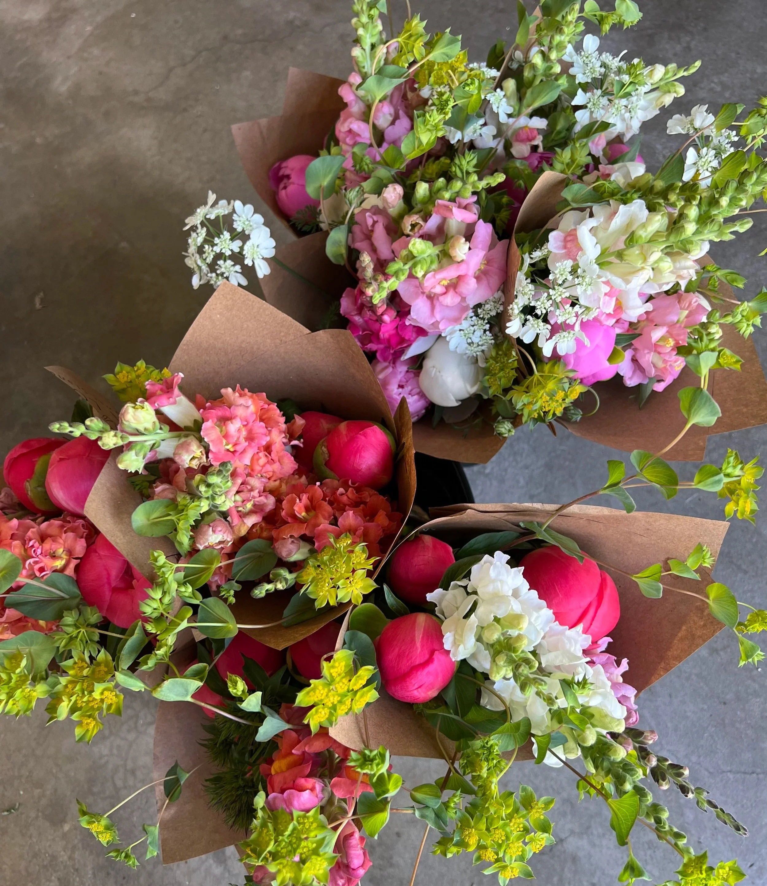 Vibrant peony bouquet at a local flower stand in Centerville, Utah, featuring fresh, locally grown flower