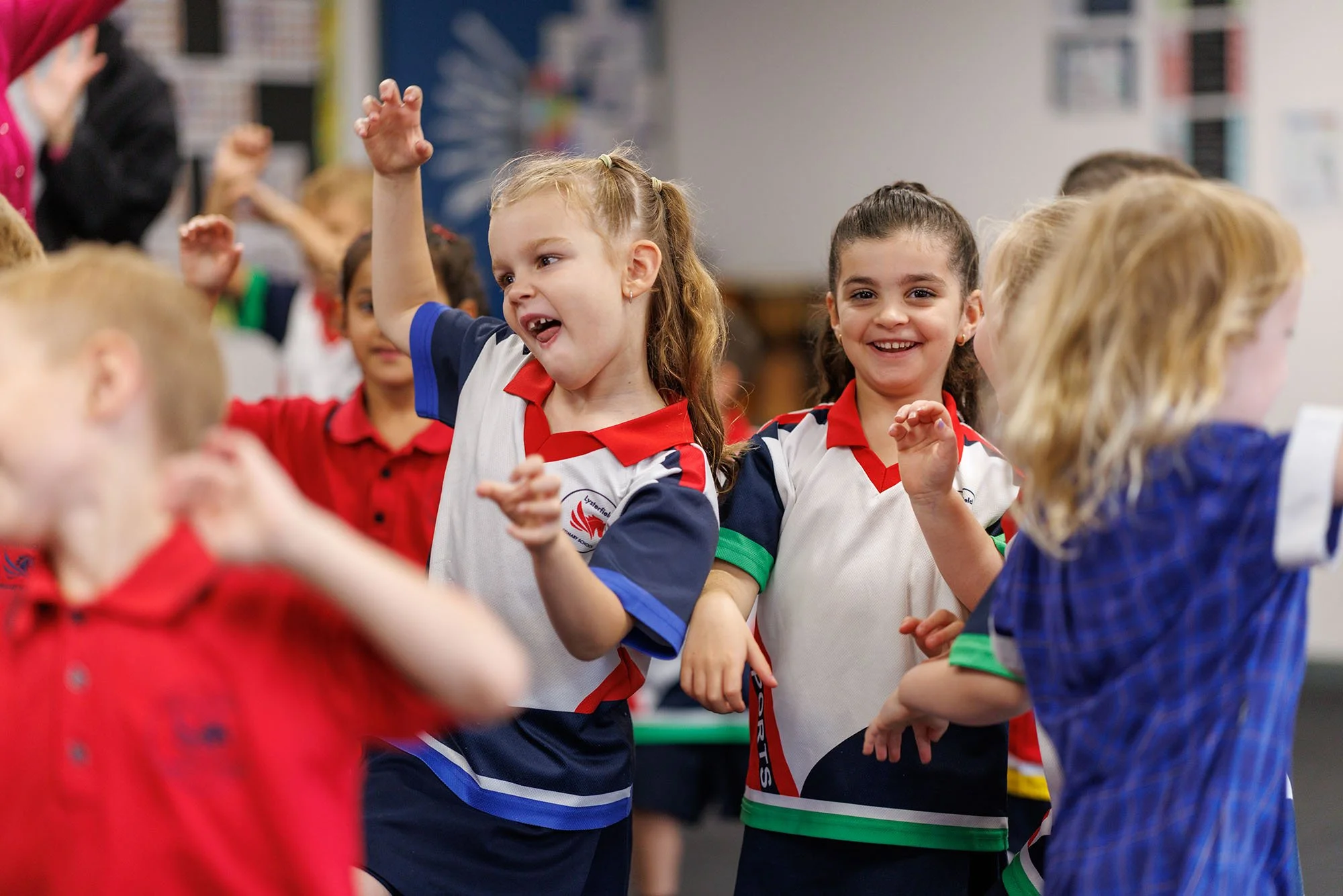 Children dancing and having fun in a classroom or school setting.