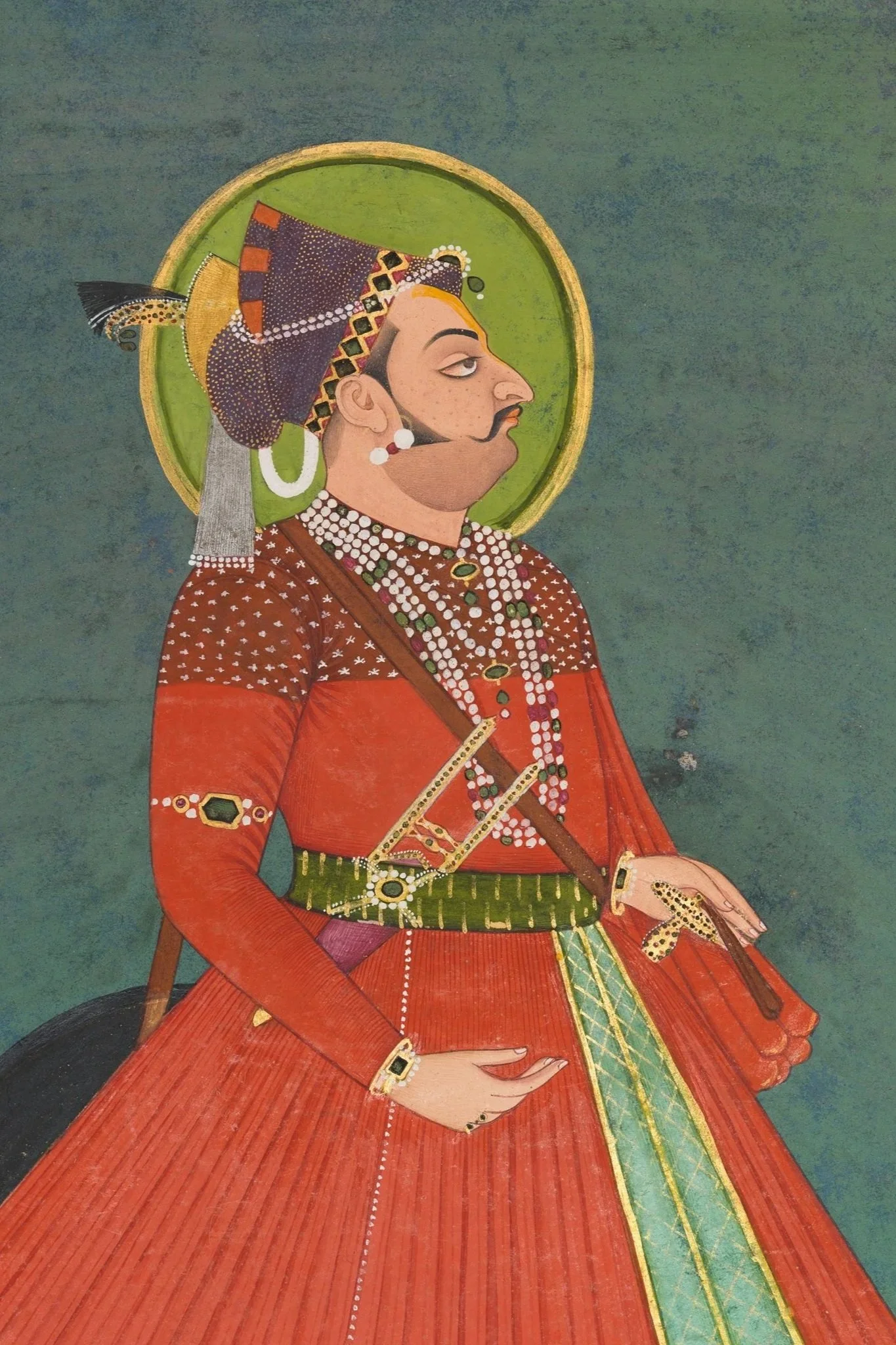 A traditional painting of a regal Indian man in profile, adorned with jewelry, wearing a red and orange garment, with a green halo in the background.