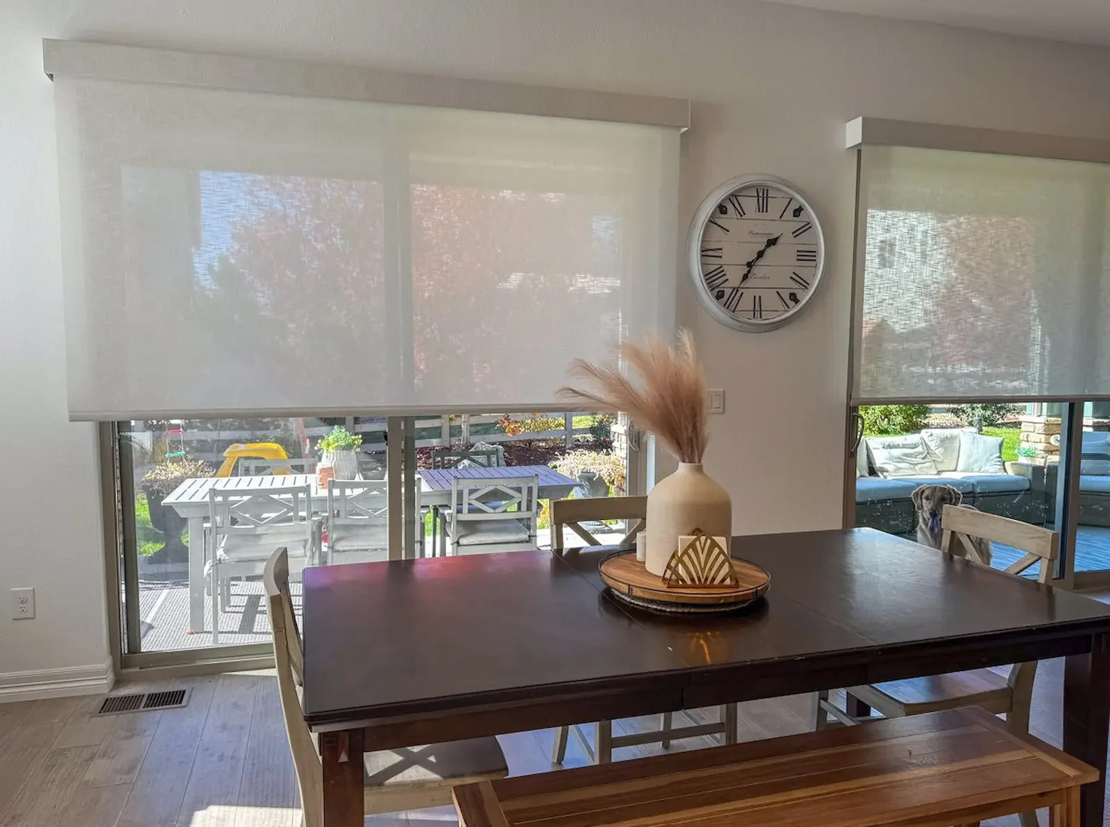 Solar shades covering sliding glass doors in a joined living, dining room