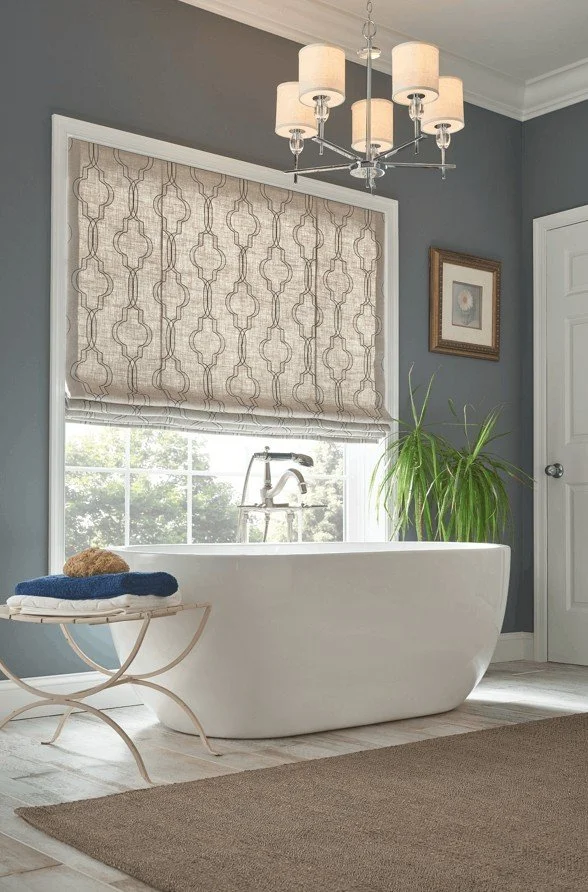 Light-filtering Roman shades partially lowered in a bathroom