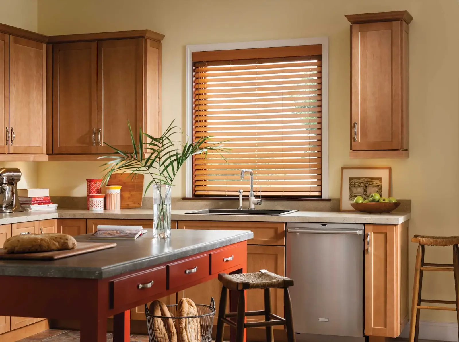 Faux wood blinds with a stain print provide a durable light and privacy solution above this kitchen sink.