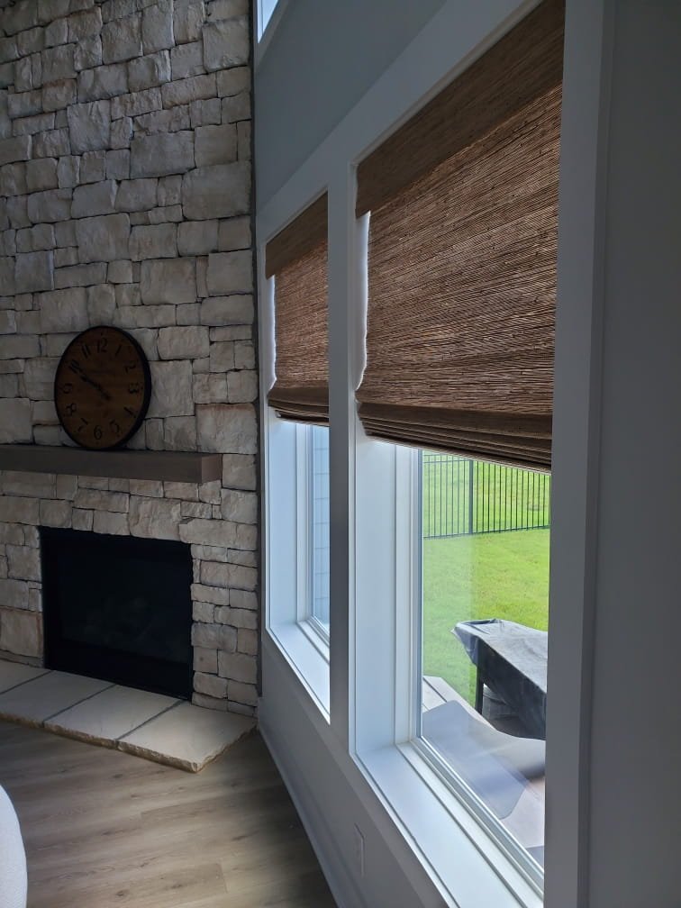 Light-filtering natural shades adding warmth to a modern farmhouse interior