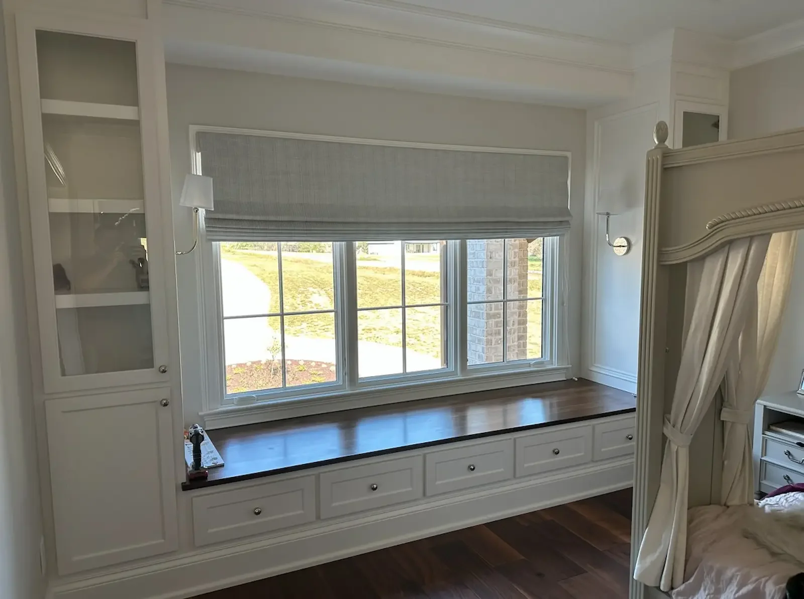 Custom Roman shades installed above a built-in window seat