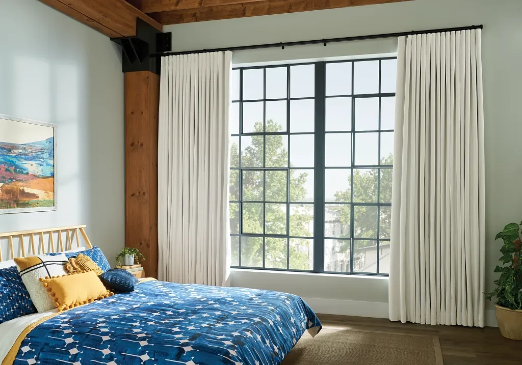 White roll pleat / ripple fold draperies open for a large window view