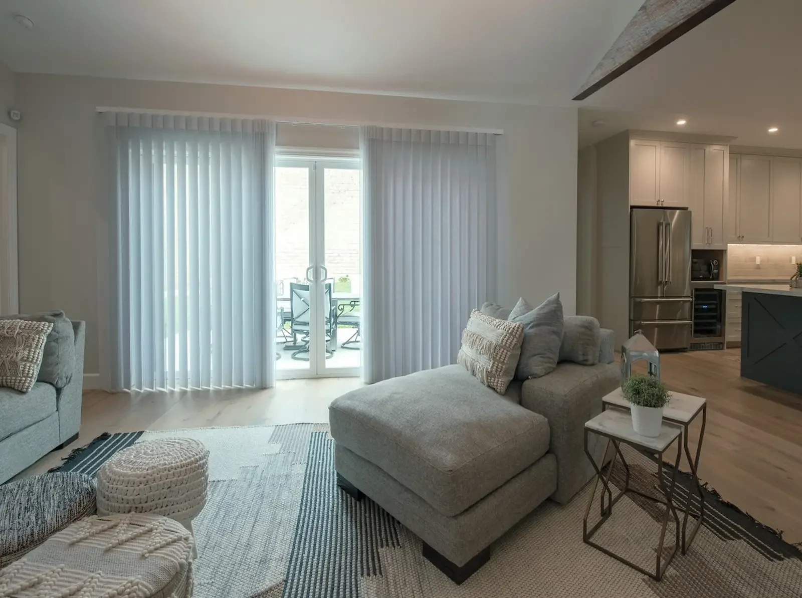 SmartDrape shades covering wide glass doors in an open living space