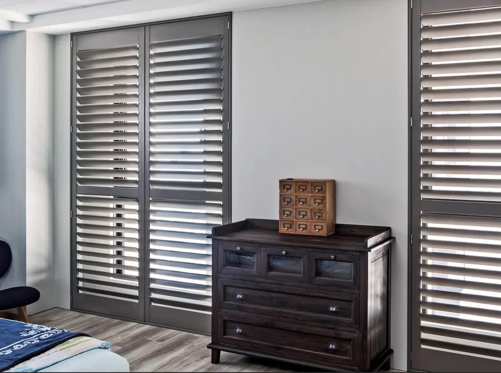 Floor-to-ceiling shutters in a beautiful color to complement the room