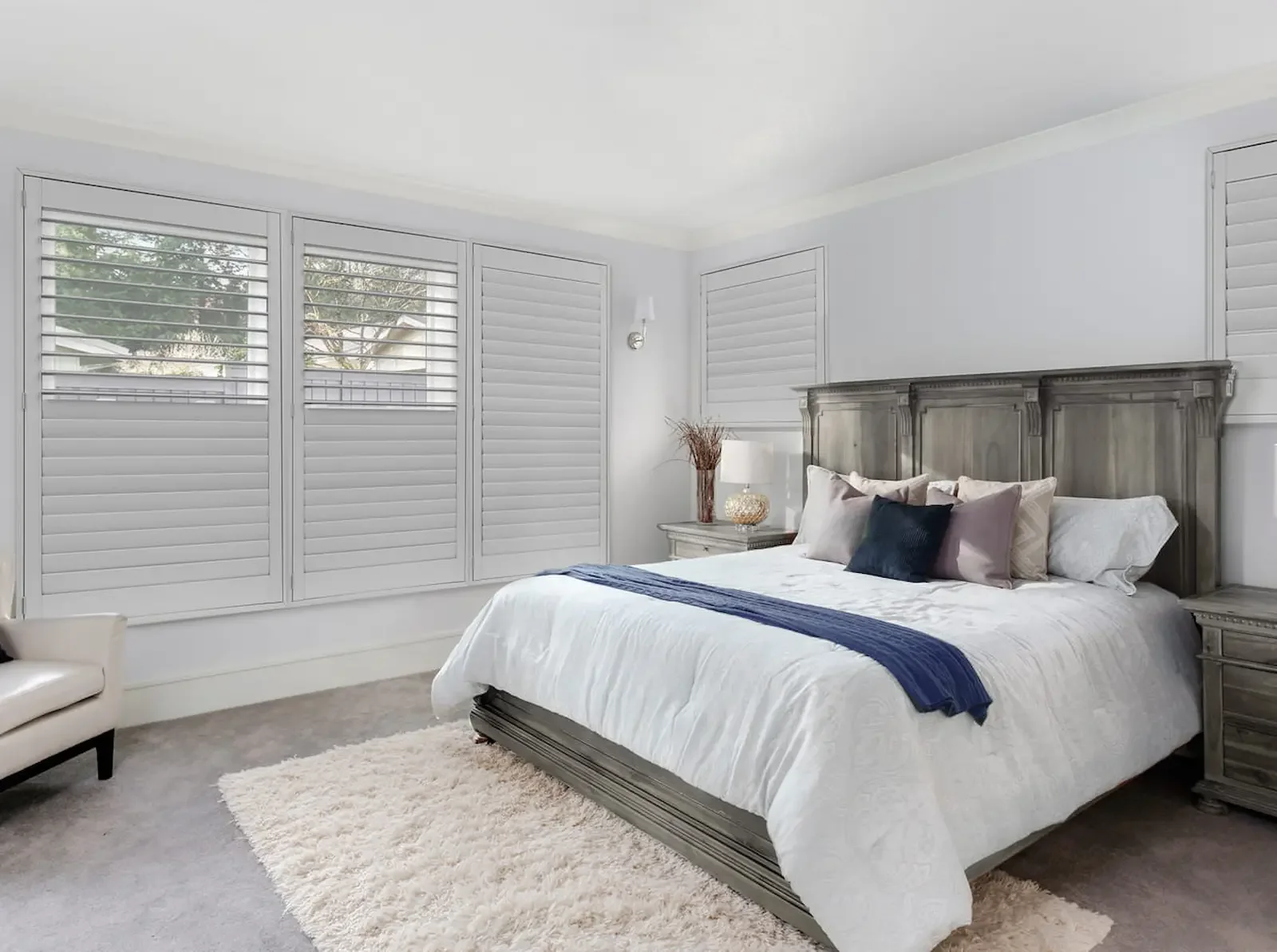 Shutters with large louvers allow for a quick transition between an open room and a sanctuary.