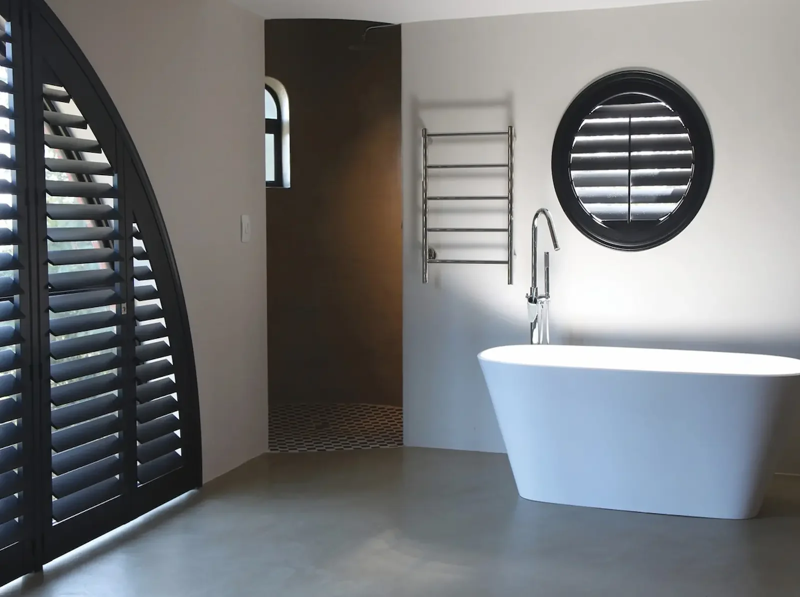 This spectacular bathroom showcases the versatility of specialty shaped shutters.