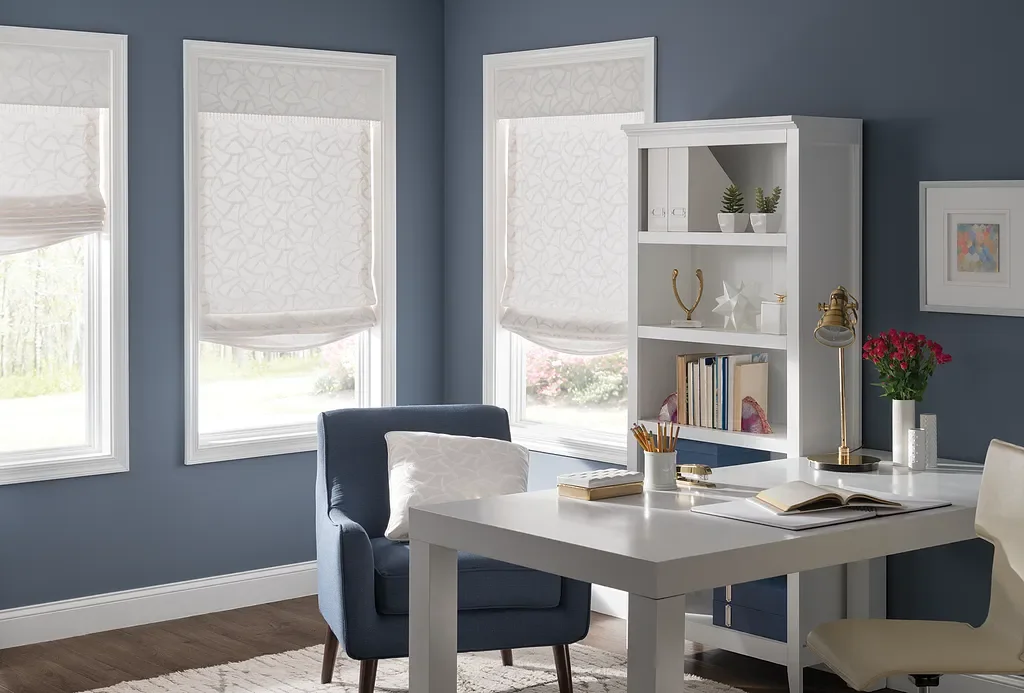 Relaxed Roman shades with soft folds over picture windows