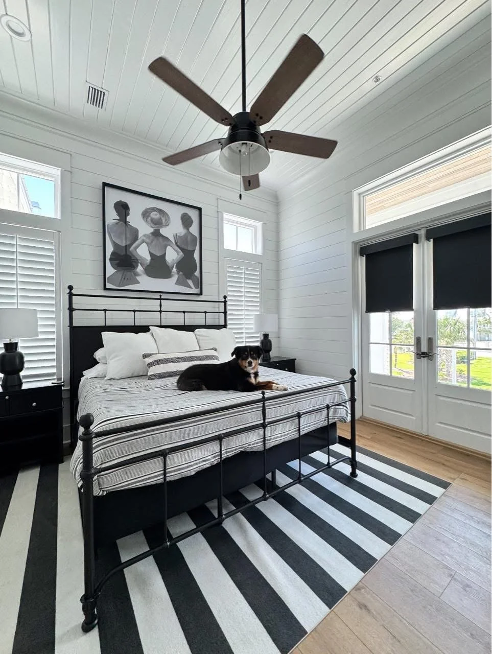 Roller shades installed on doors paired with white plantation shutters