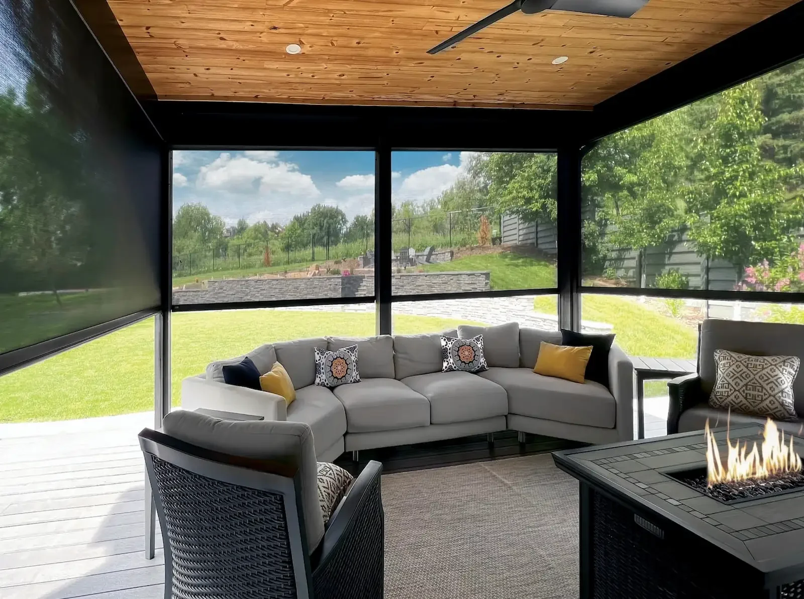 Exterior screen shades with zipper tracks reduce heat and keep the patio bug free.