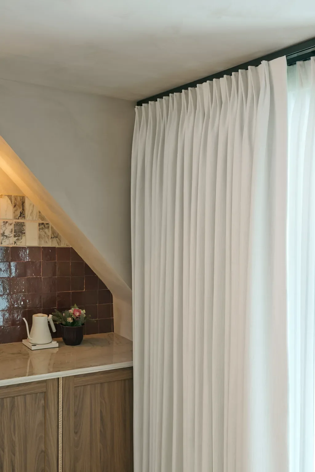 Ceiling mounted blackout drapery stacked back