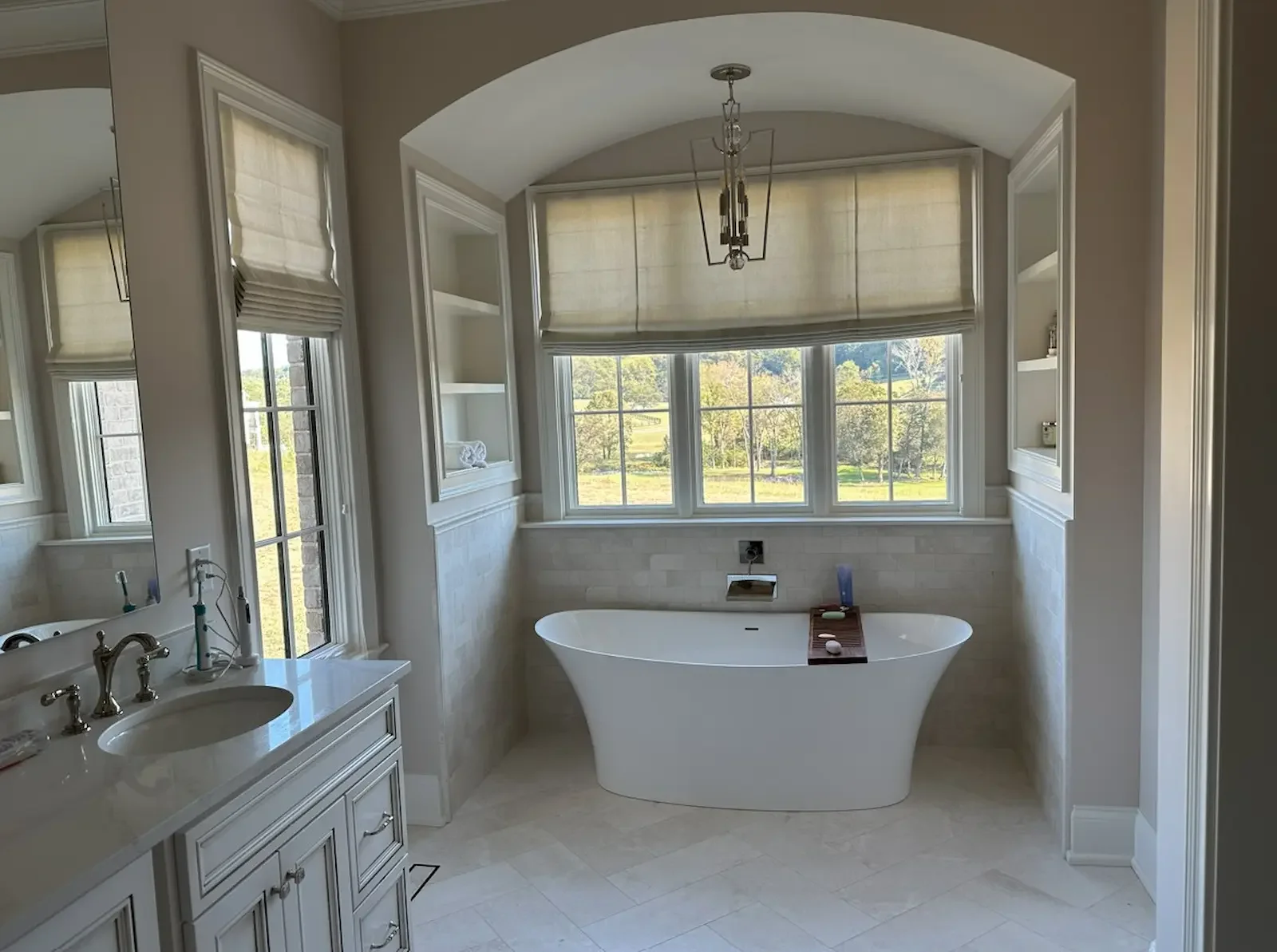 Custom Roman shades professionally installed in a remodeled bathroom