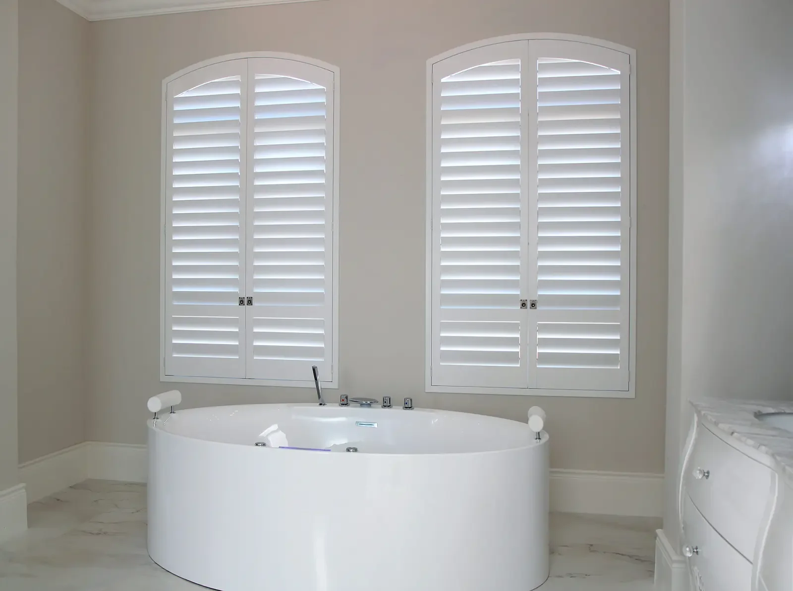Arch panel shutters with a low divider rail and optional ring pulls