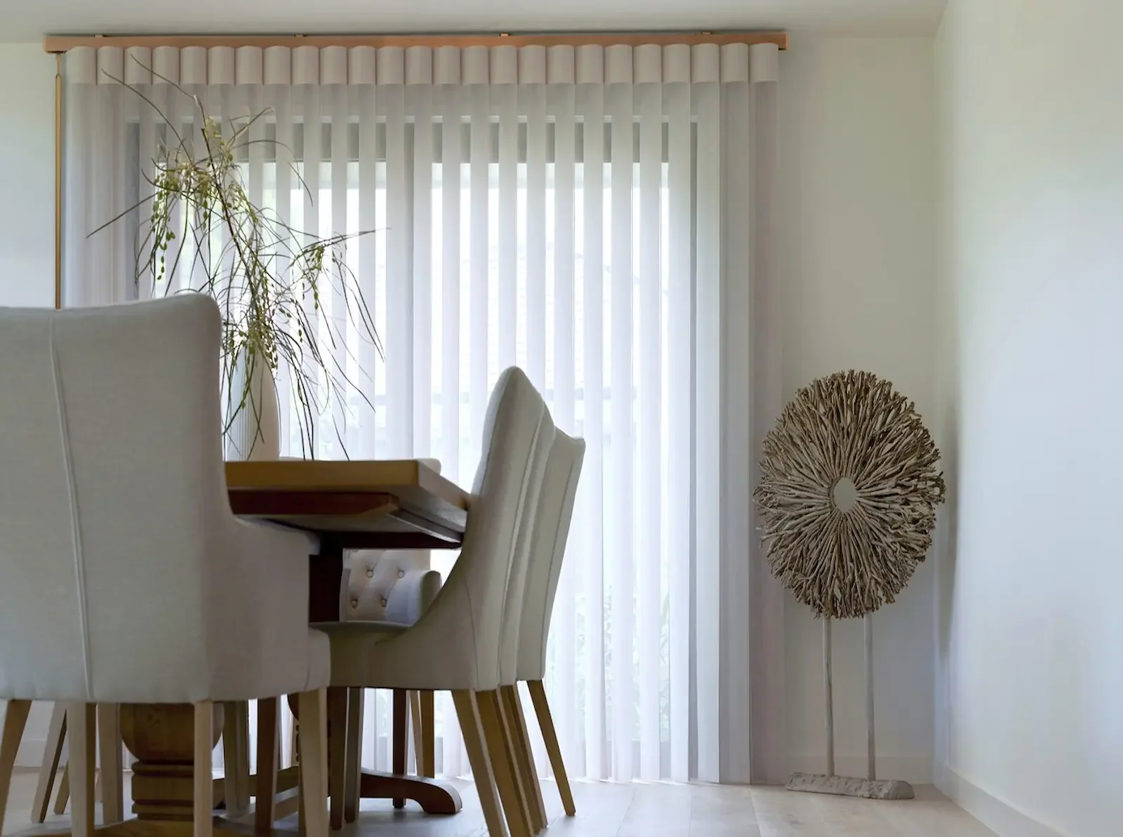 SmartDrape shades with brushed gold hardware mounted above sliding doors for full coverage